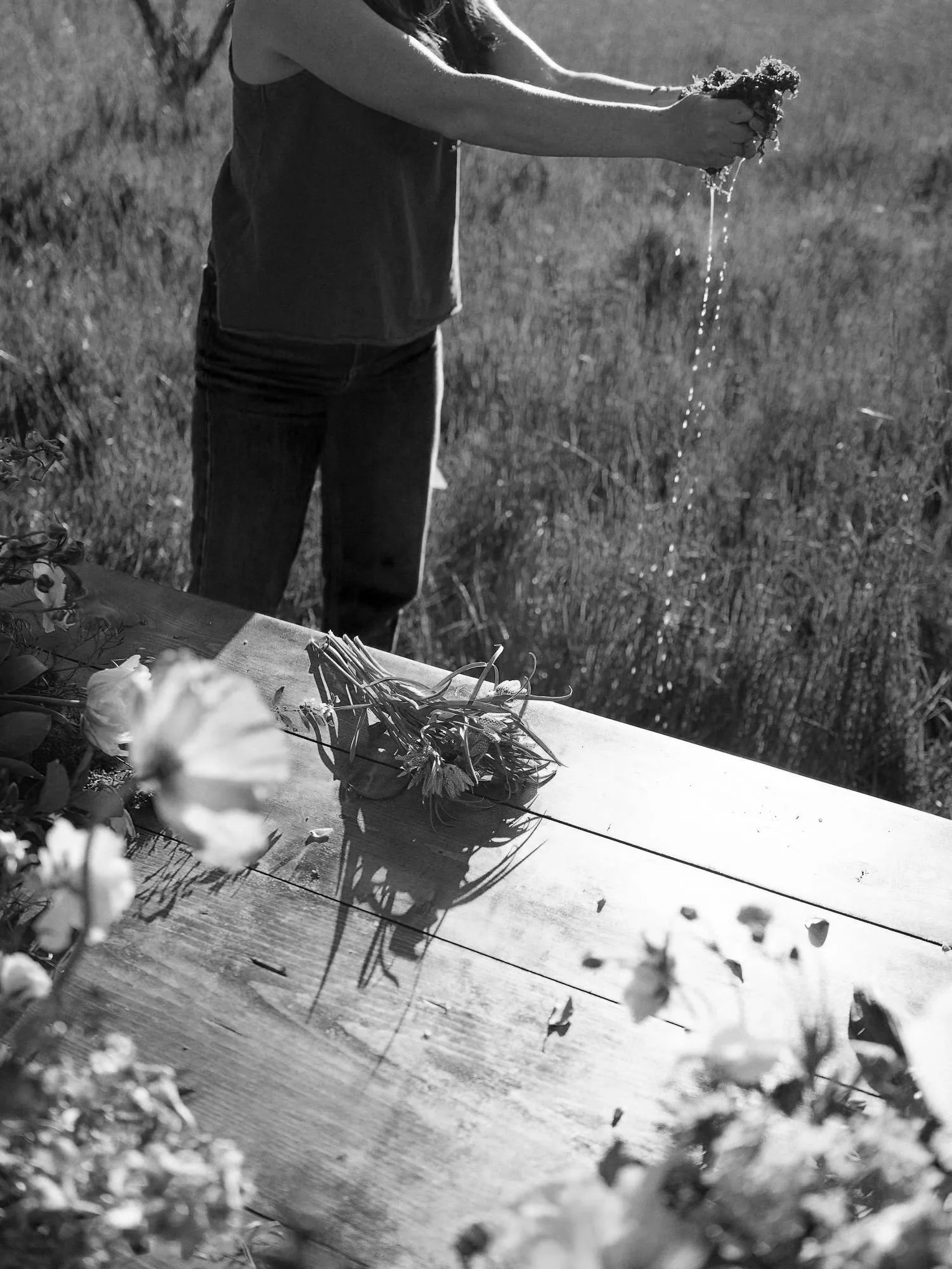 Lauren assembling a custom bouquet in the middle of a field on her flower farm.
