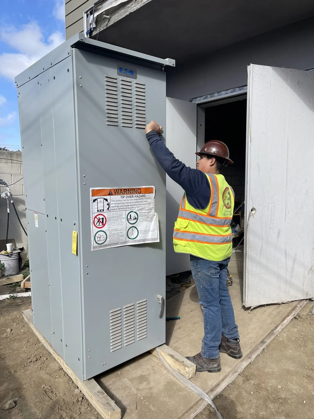 Muntiz Electric crew setting new electrical gear