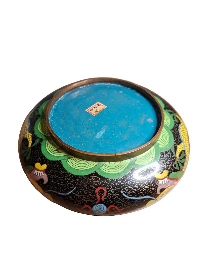 View of  the bottom of an antique bowl, This striking Chinese bowl dates from the early 20th century and showcases the bold artistry of traditional cloisonné enamelling.