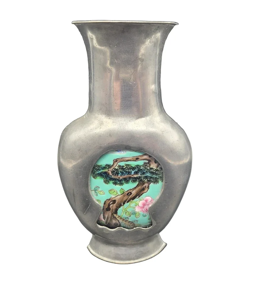An unusual Chinese white metal or pewter baluster vase is a finely crafted decorative piece, designed with a flat back for wall mounting or use within a sedan chair.
