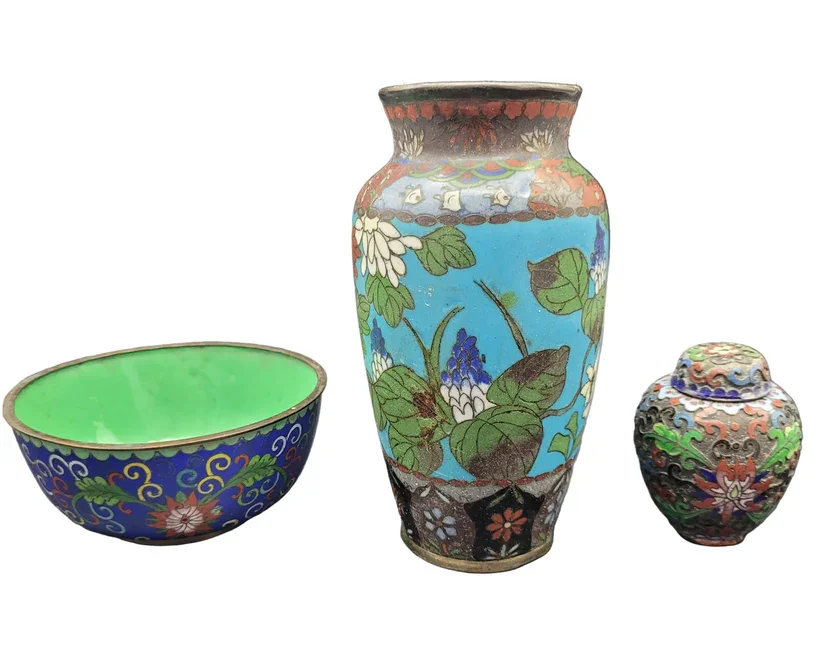 three-piece Japanese cloisonné set, comprising a vase, ginger jar, and bowl, each beautifully decorated with the intricate artistry and vibrant enamel work