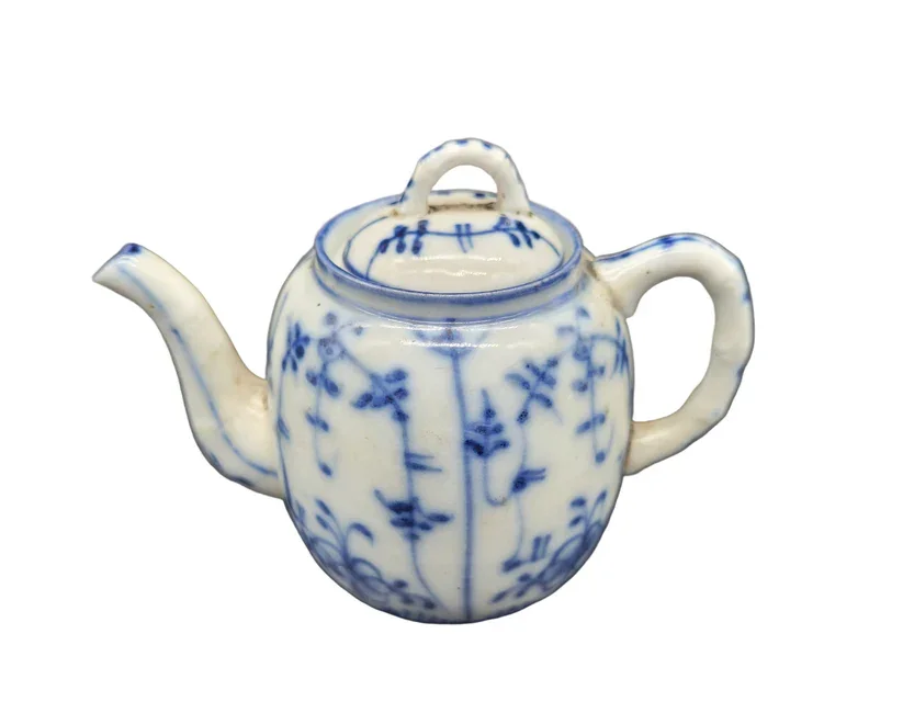 This 19th-century Oriental miniature teapot is a fine example of antique porcelain artistry.