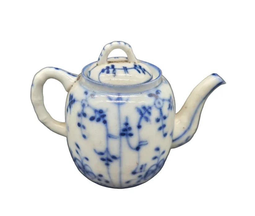 Oriental miniature teapot, a fine example of antique porcelain artistry.