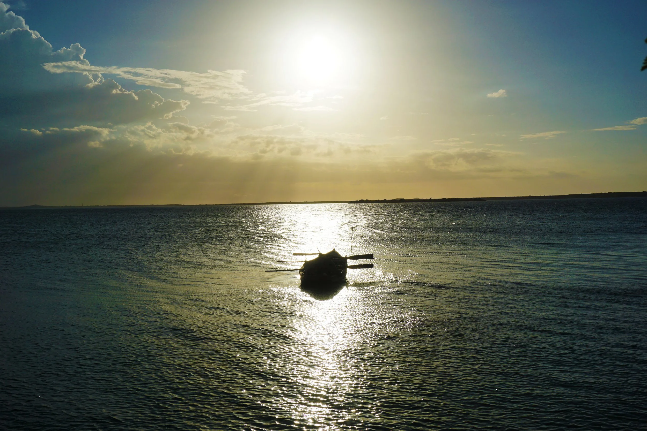 A row boat in calm water during sunset