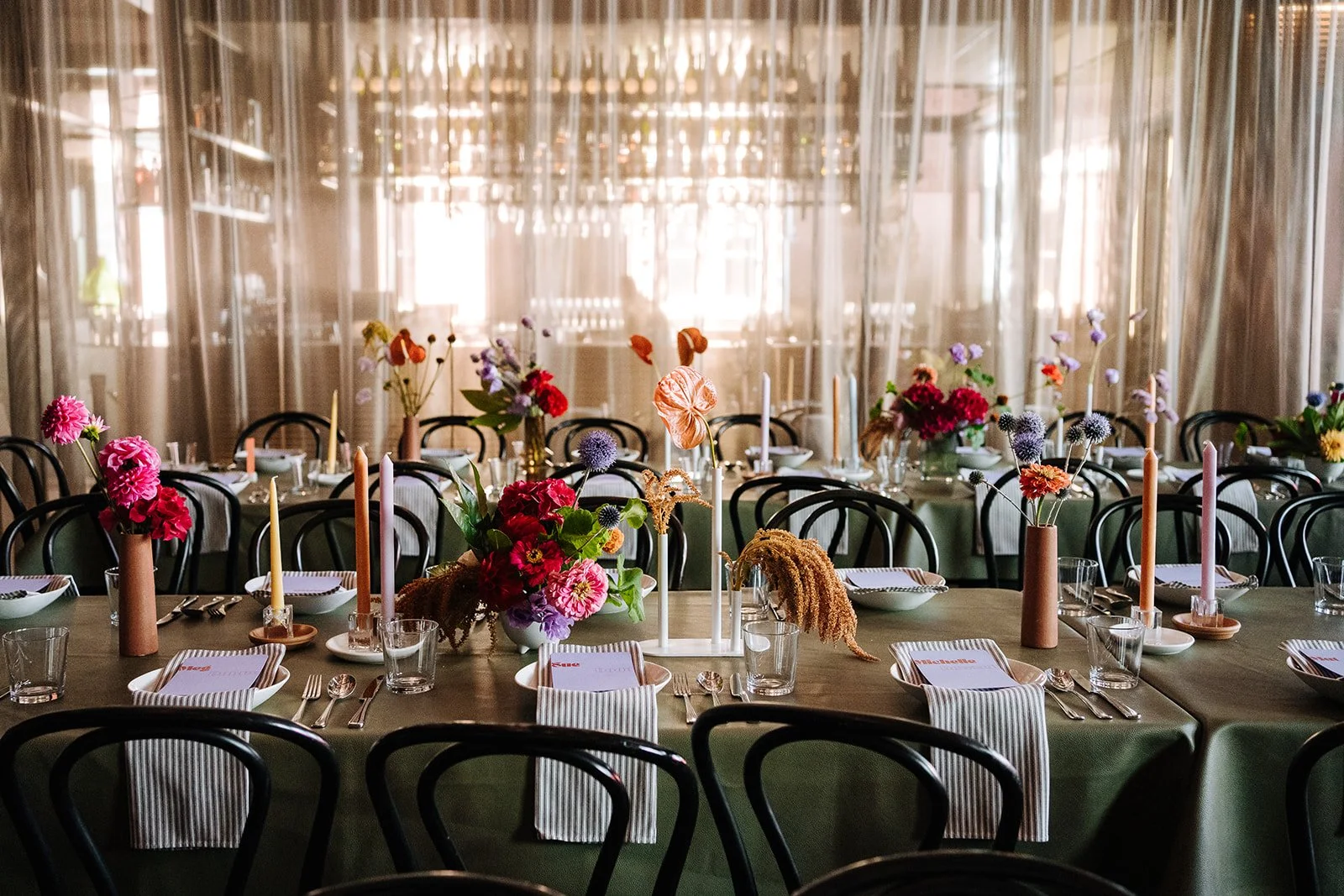 A decorated banquet table with floral centerpieces, colorful flowers, candles, and place settings for a celebration or event in Longsong. 