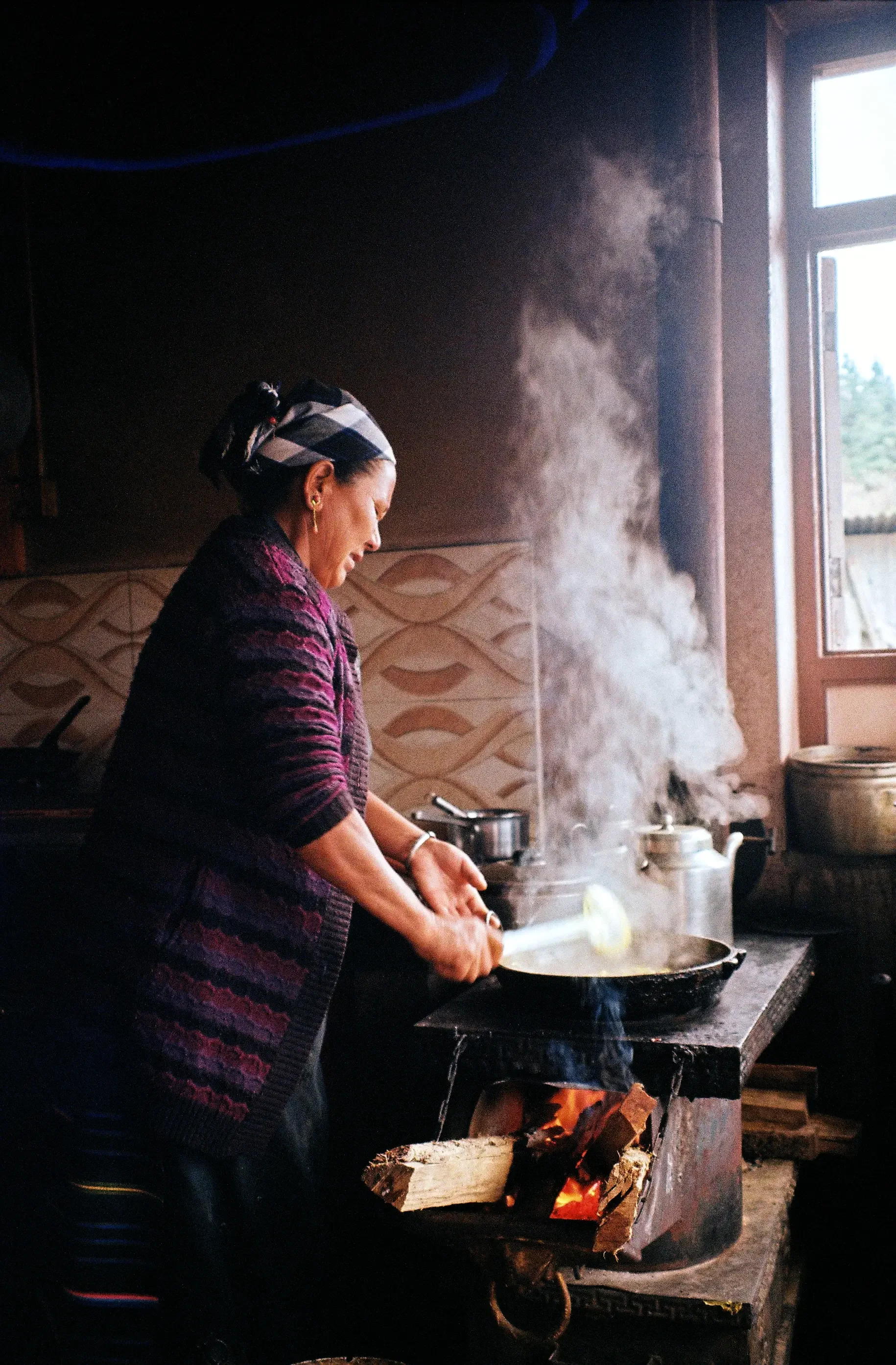 Tamang woman cooking Dal Bhat, nepal