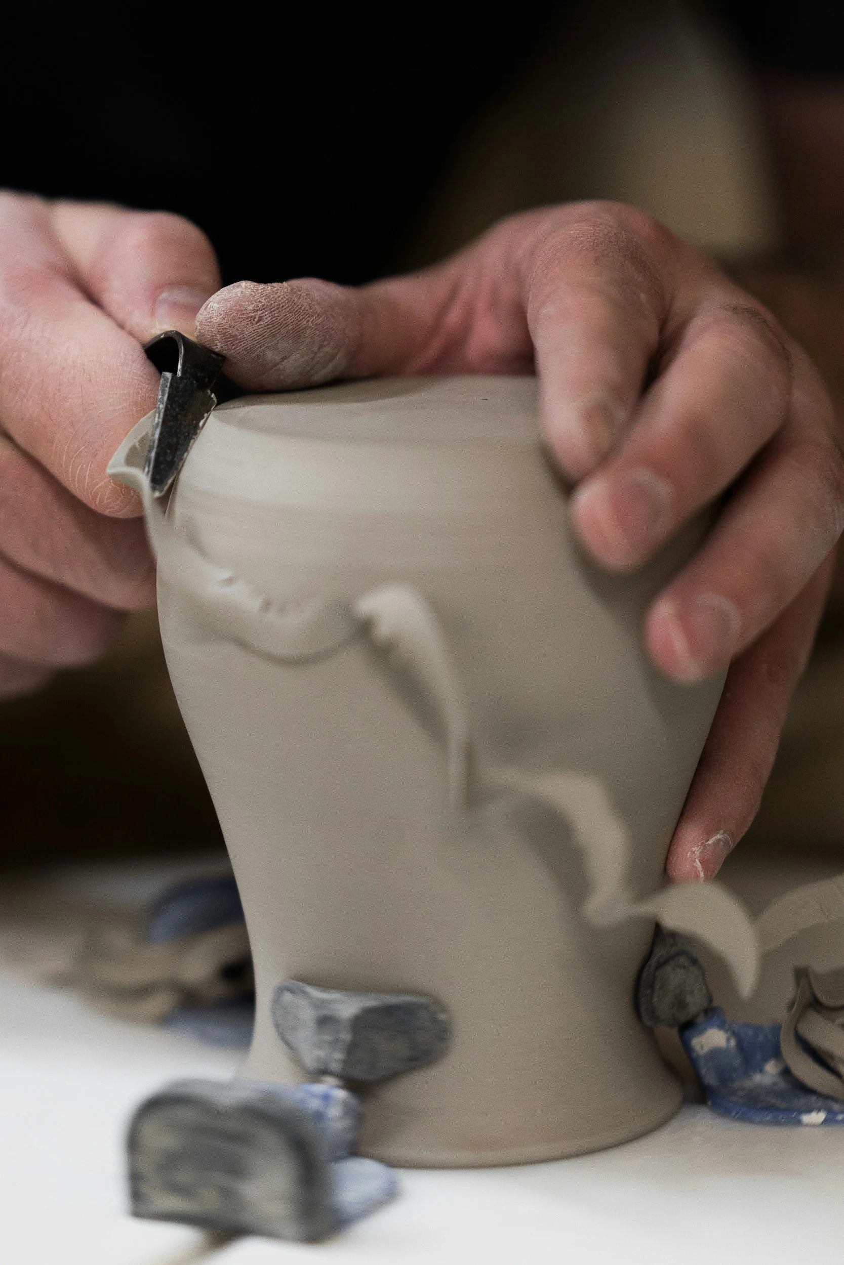 a potter trimming clay