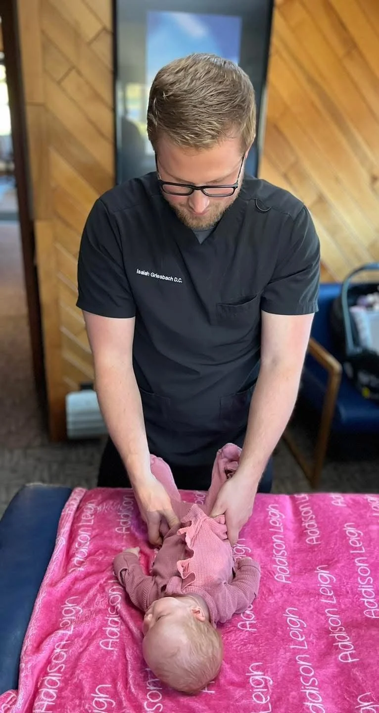Dr. Griesbach performing an adjustment on a young baby.