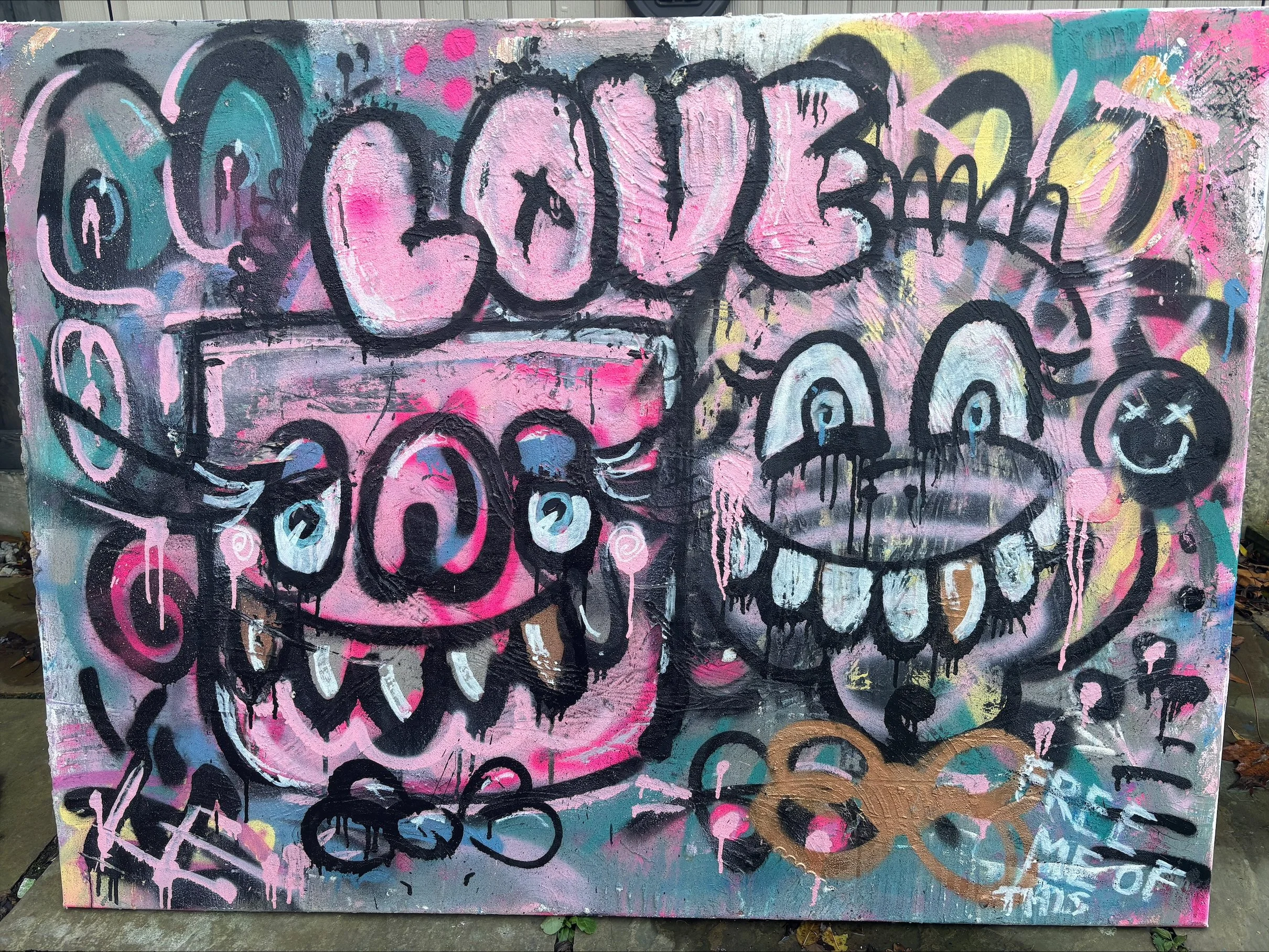 Colorful graffiti artwork featuring two smiling cartoonish skull faces, with the word 'LOUD' above them, surrounded by abstract colors and shapes.