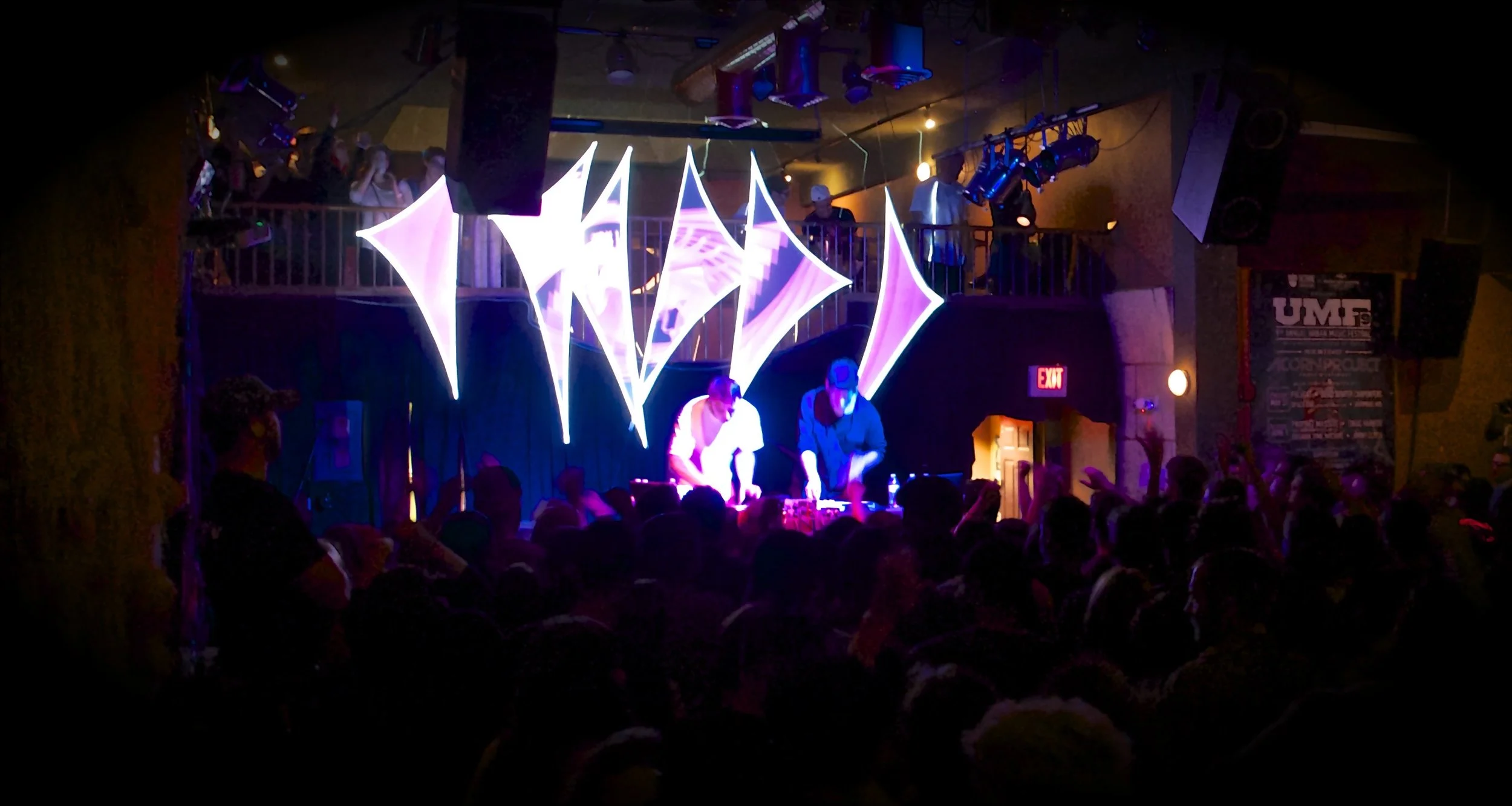 Projection mapped stretch fabric sails glowing pink and violet above ODESZA on stage at the Wild Buffalo in Bellingham, Washington