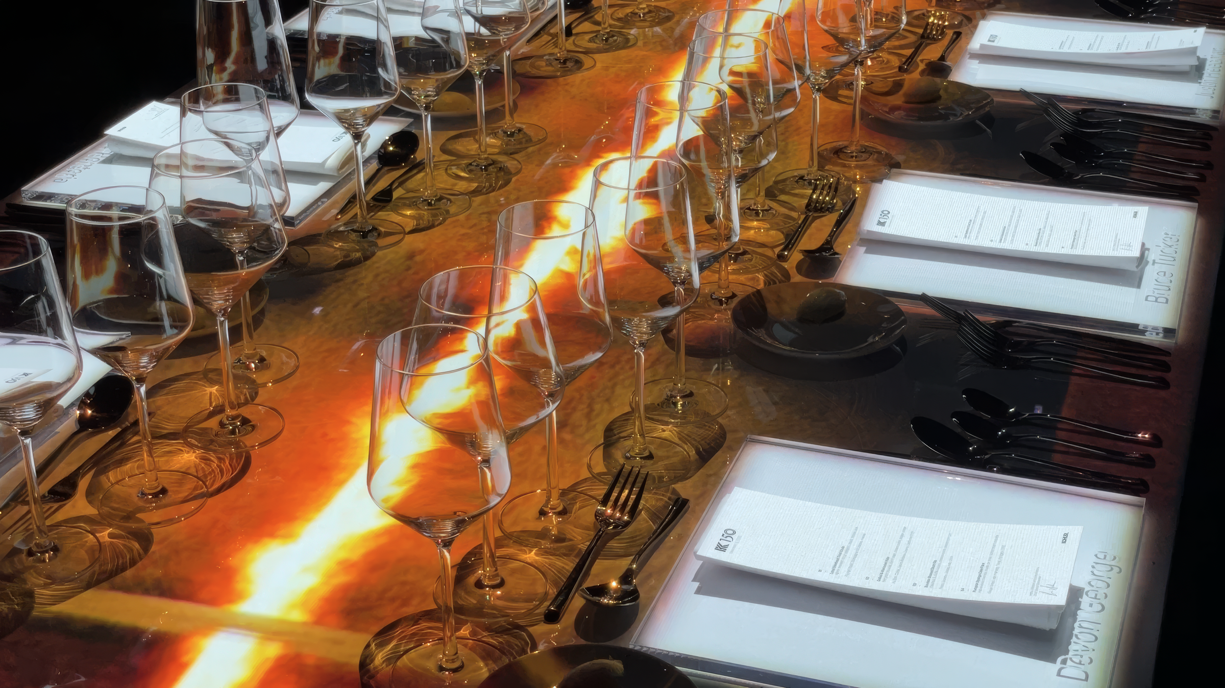 Immersive projection dining by NOVA Light Labs with molten gold light running the length of the table