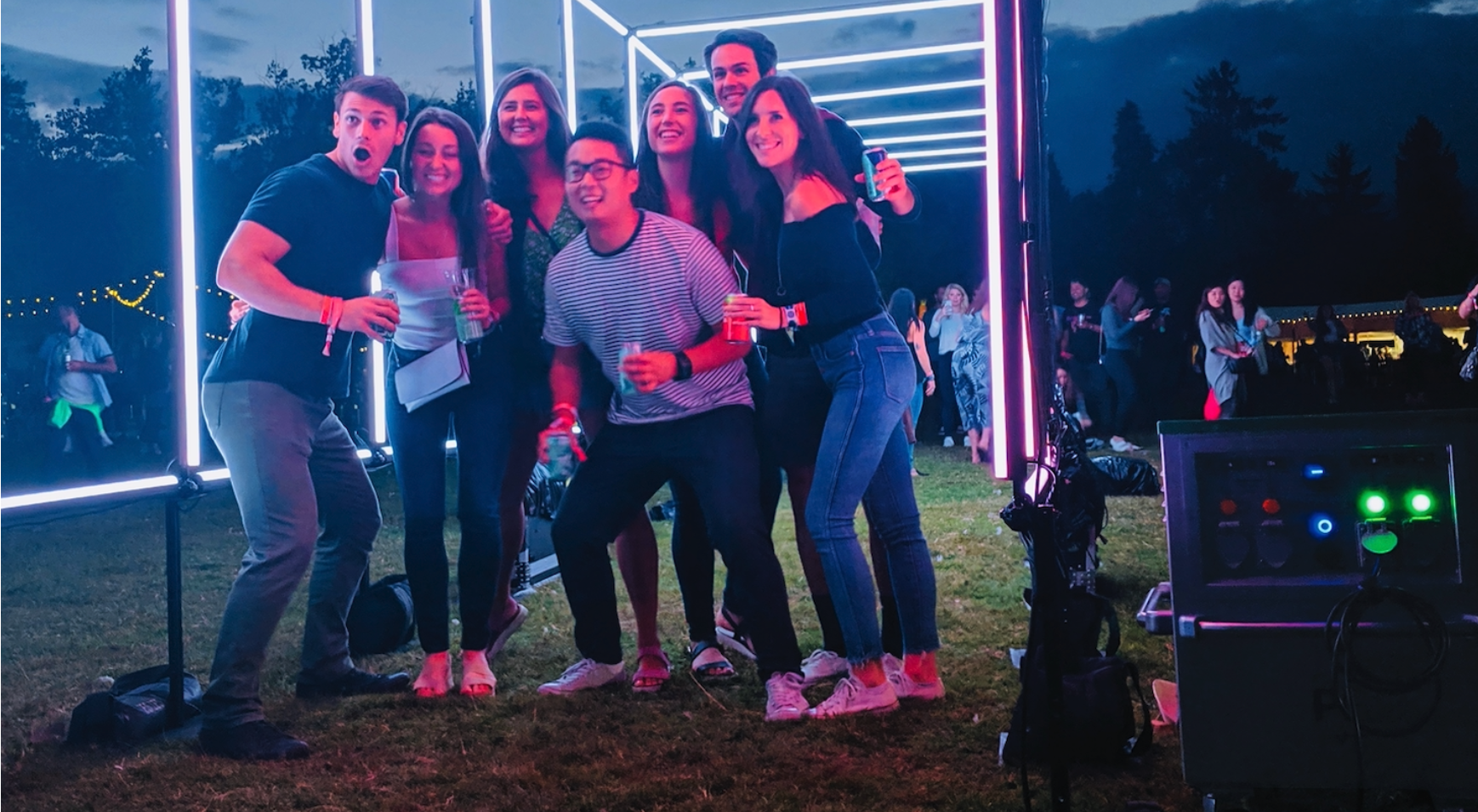 lululemon SeaWheeze LED tunnel entrance, group of 7 friends posing together inside the glowing frame