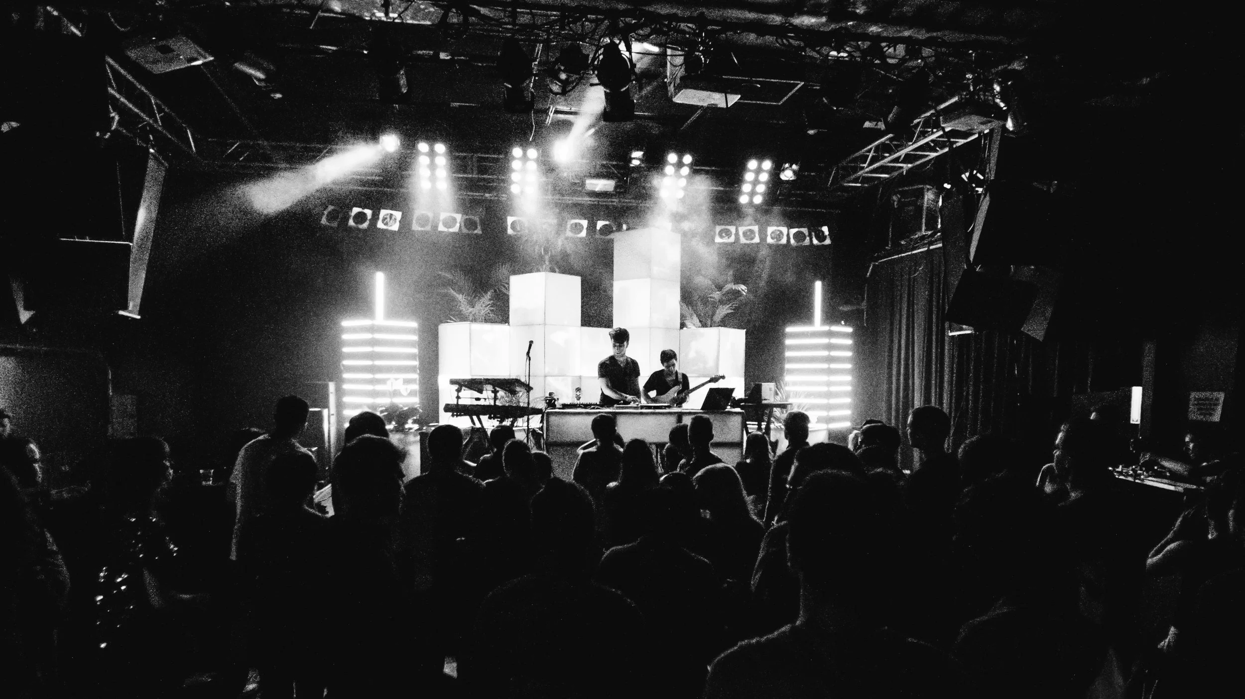 Live From Space stage at Neumos in Seattle with CUBIX cubes lit white above a packed crowd in black and white