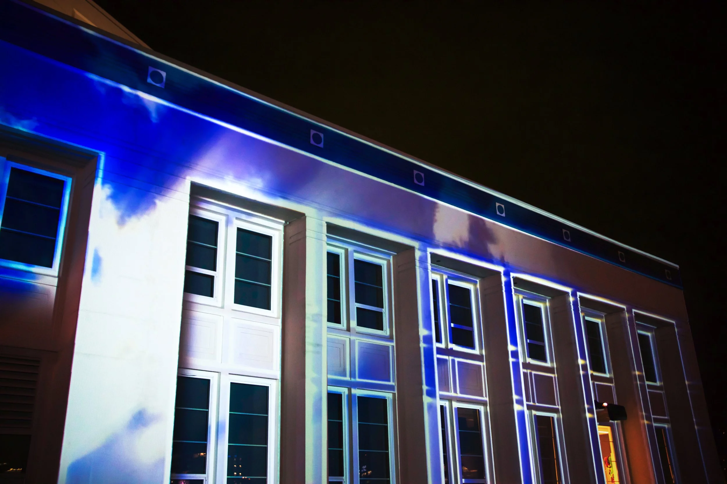 Microsoft at MOHAI projection mapping in Seattle, blue cloud visuals across angled facade windows.