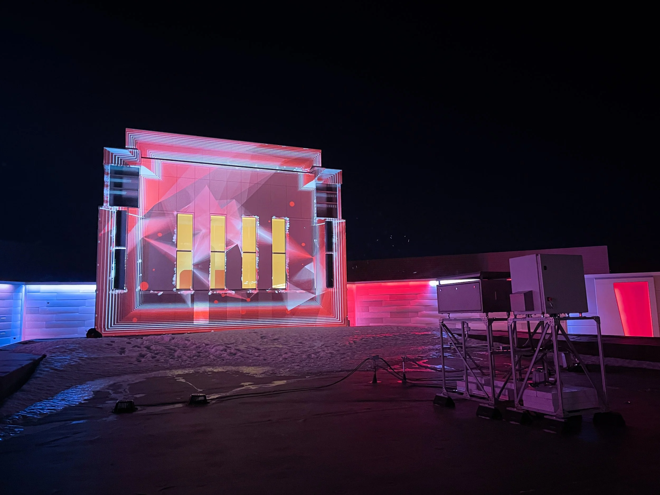 Running Aces Casino projection mapping system, night view of the mapped facade beside the projector enclosure.