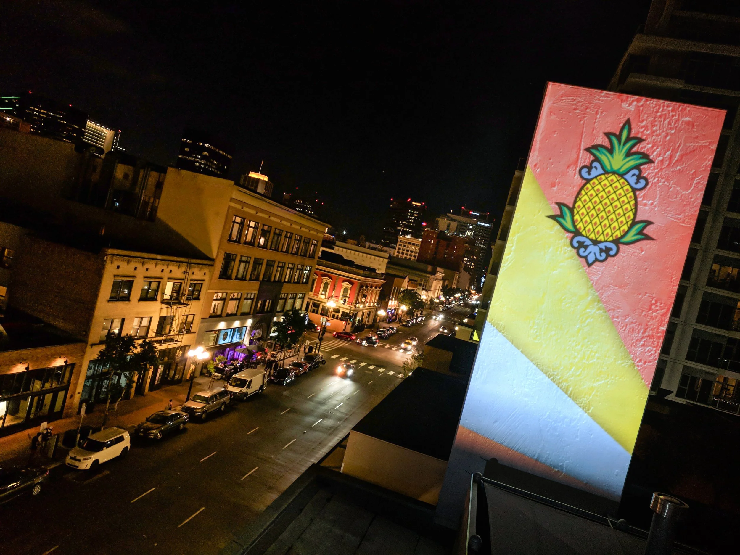 Hotel Z projection mapping in San Diego Gaslamp Quarter, pineapple logo lit above the downtown street