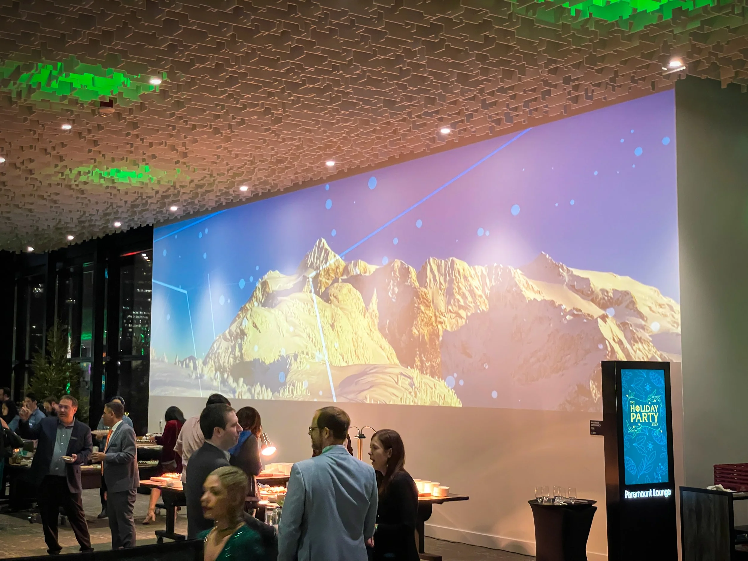 Projection mapped mountain scenery above the main bar at the Seattle Convention Center, guests gathered at the Paramount Lounge.