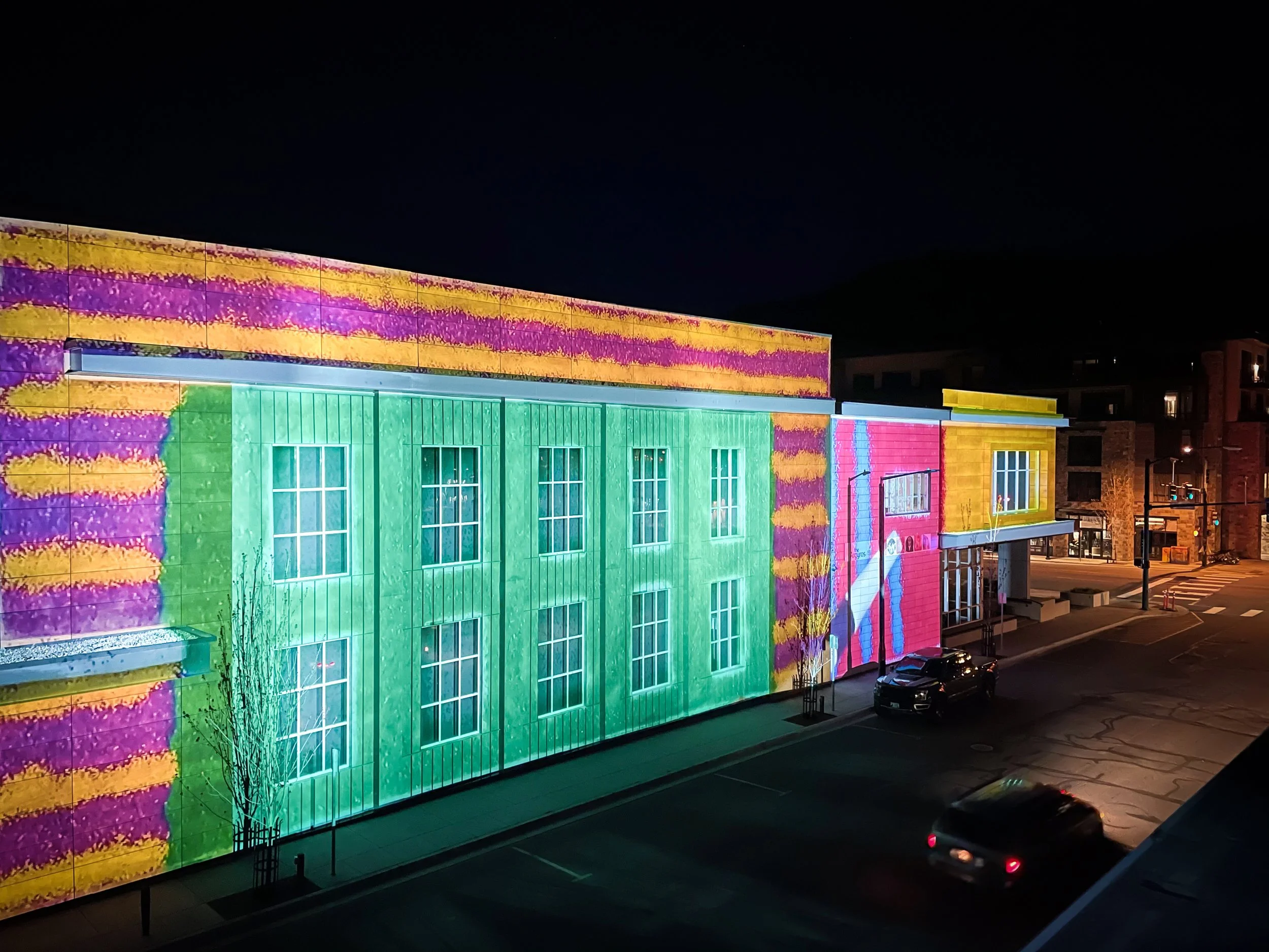 The Argyros projection mapping in Ketchum, Idaho, angled night view of the color washed facade