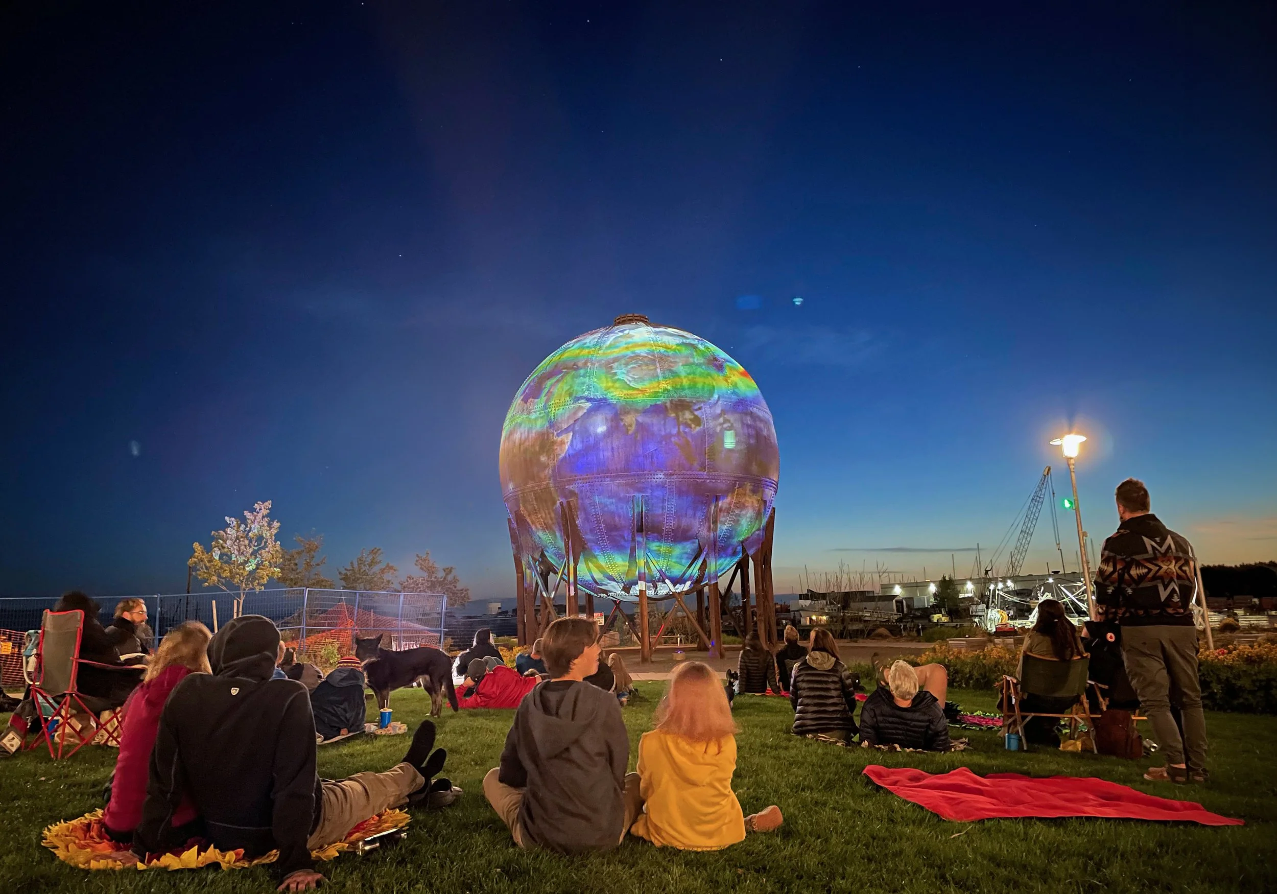 Bellingham Acid Ball projection mapping at Waypoint Park, crowd watching the lit sphere from the grass