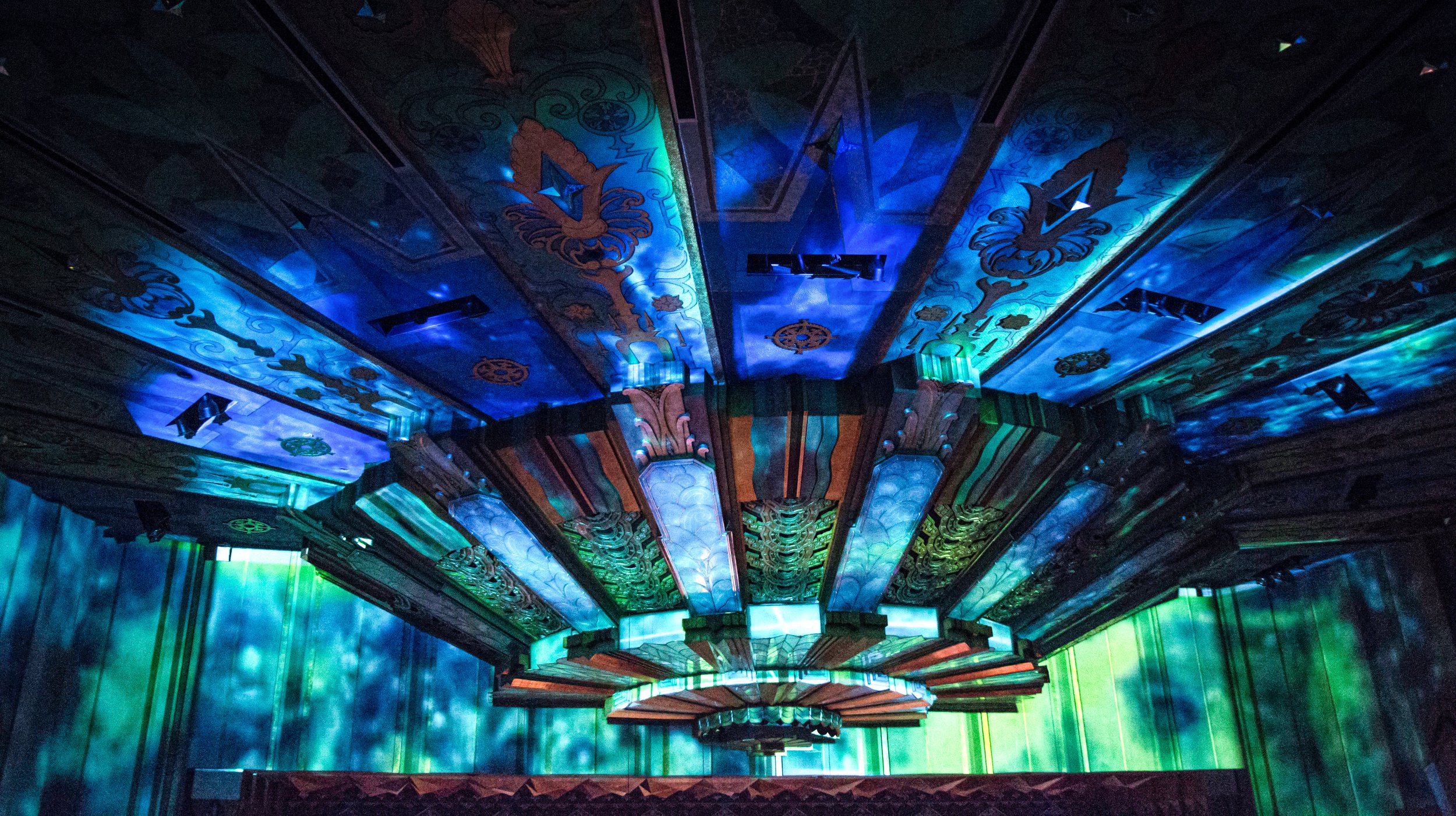 Projection mapping in blue and green across the Art Deco ceiling and chandelier of the Fox Theater in Spokane, Washington by NOVA Light Labs