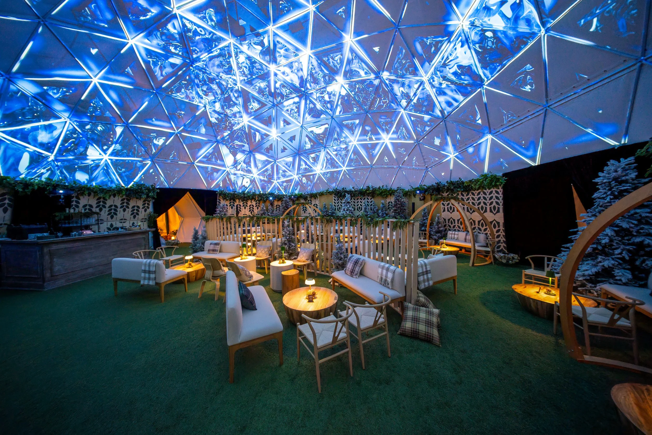The Dome at Hi-Lawn DC, geodesic dome projection mapping glowing blue above the winter lounge