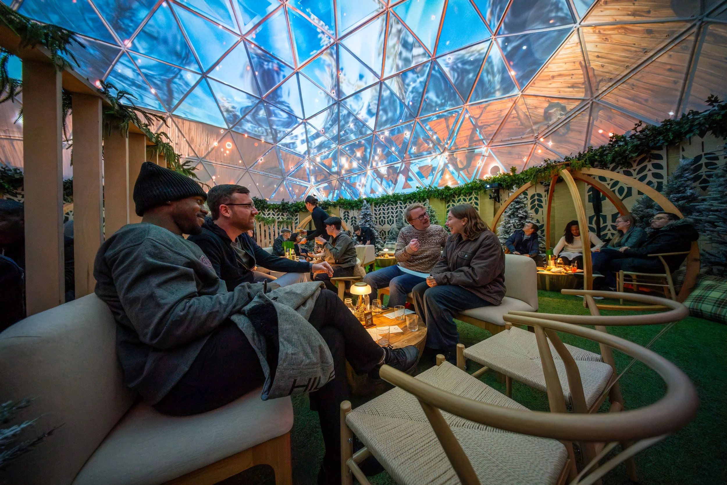 The Dome at Hi-Lawn DC, guests relax on lounge sofas beneath the immersive projection dome