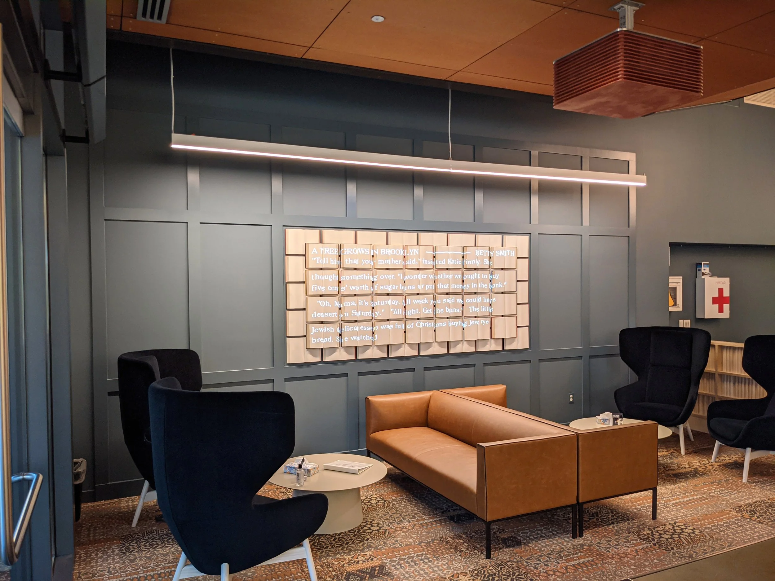 Amazon Seattle headquarters projection mapping installation, wide view of the lit book sculpture in the lobby.