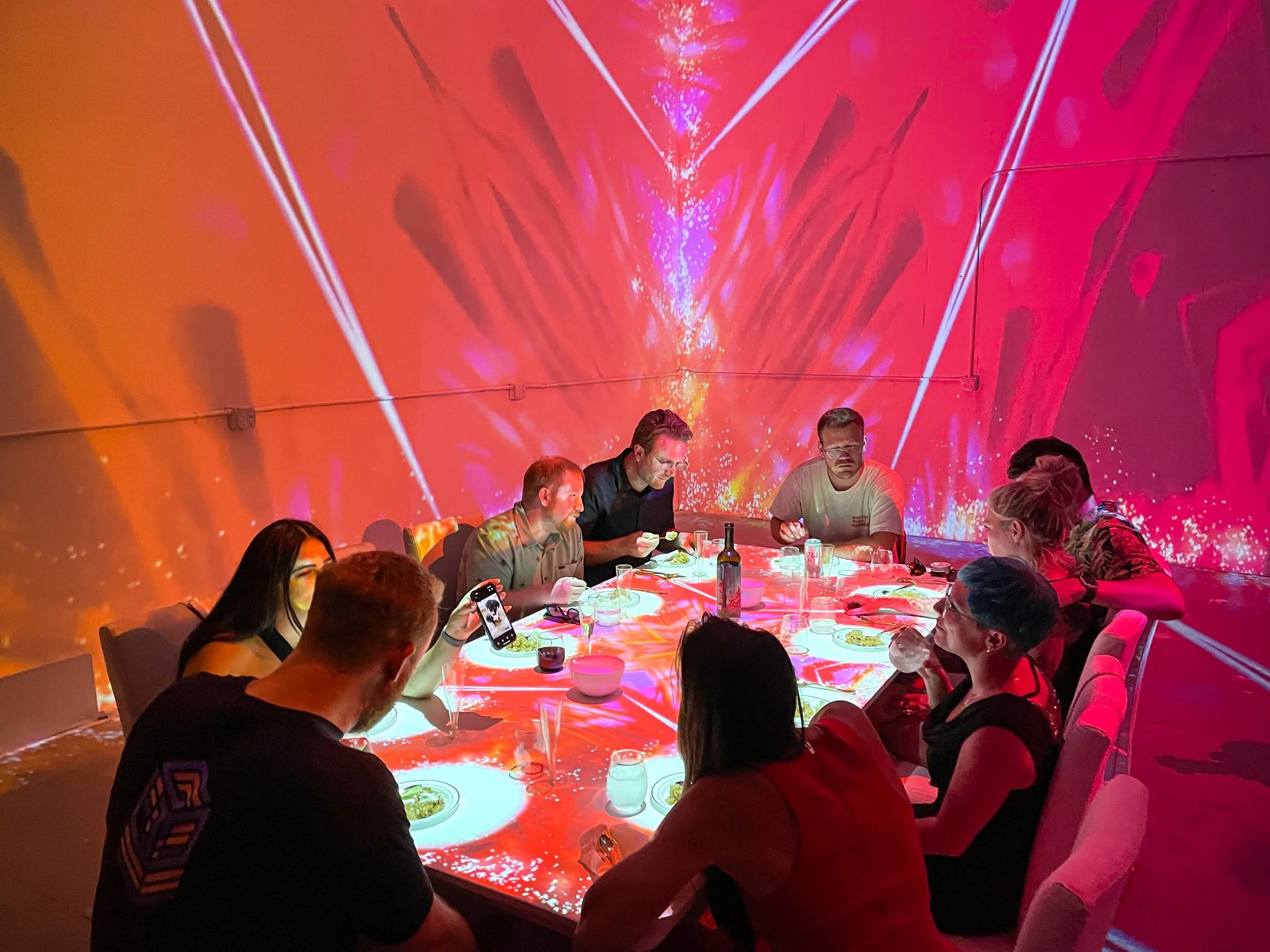 In Studio Immersive Projection Dinner at NOVA Light Labs, guests dining under a red cosmic burst