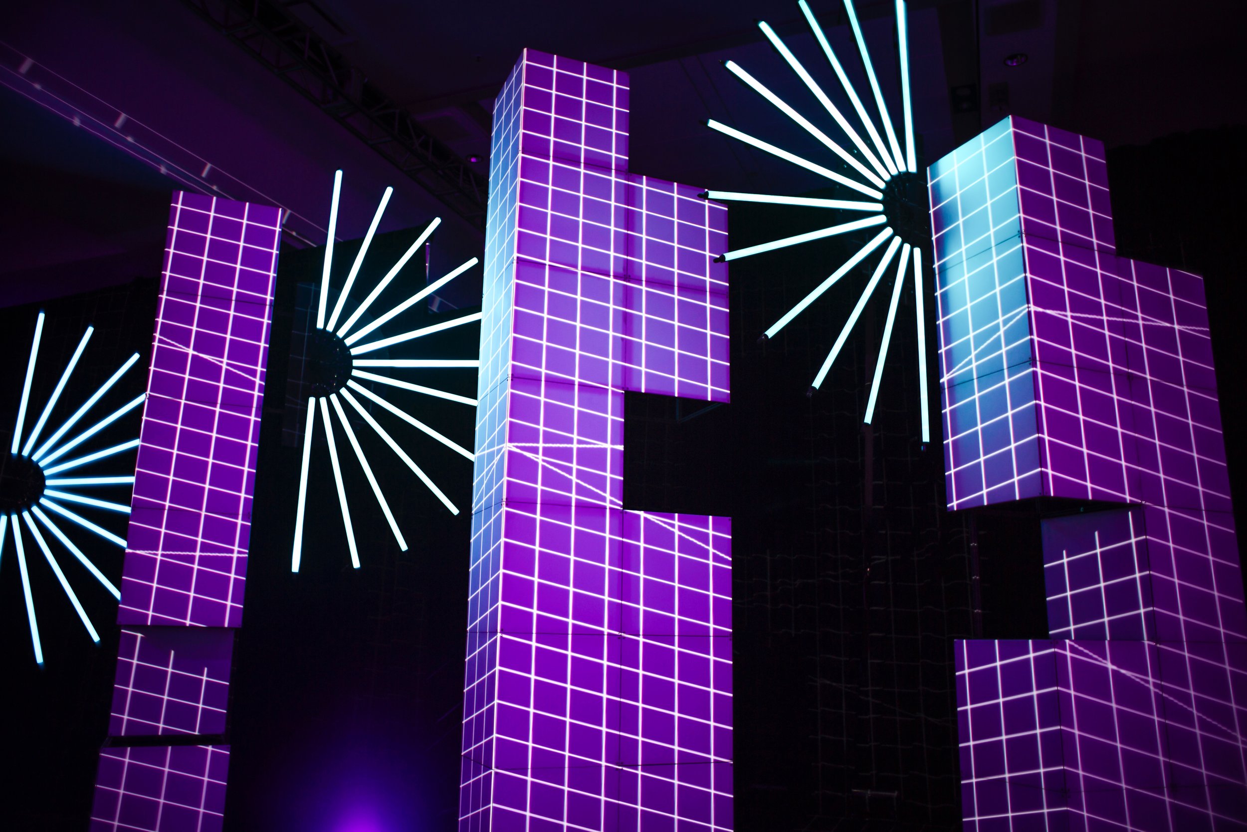 SPIE PRISM Awards projection mapping at Photonics West, purple grid content on towering cube stacks