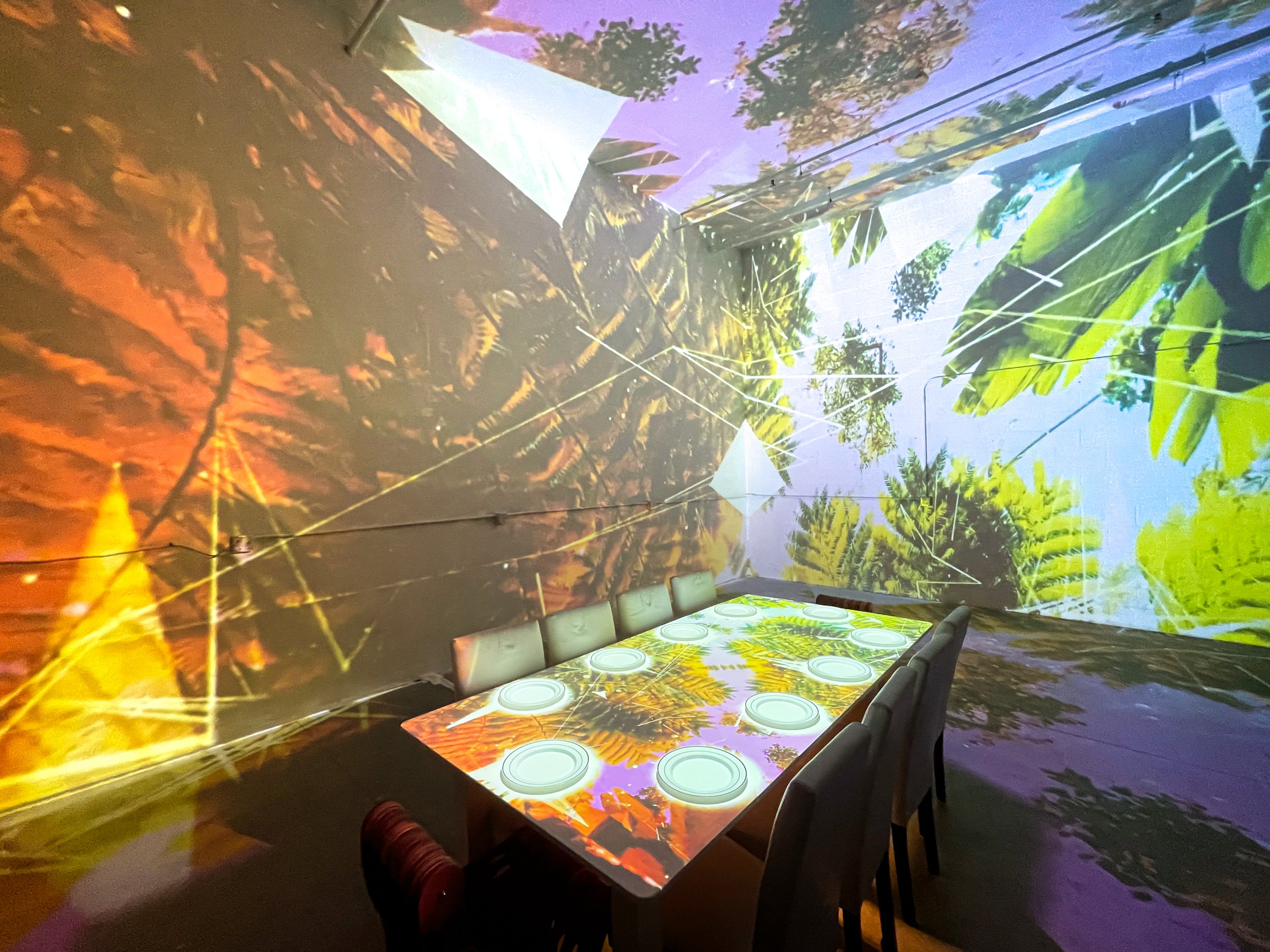 In Studio Immersive Projection Dinner at NOVA Light Labs, jungle visuals wrapping walls, floor, and table