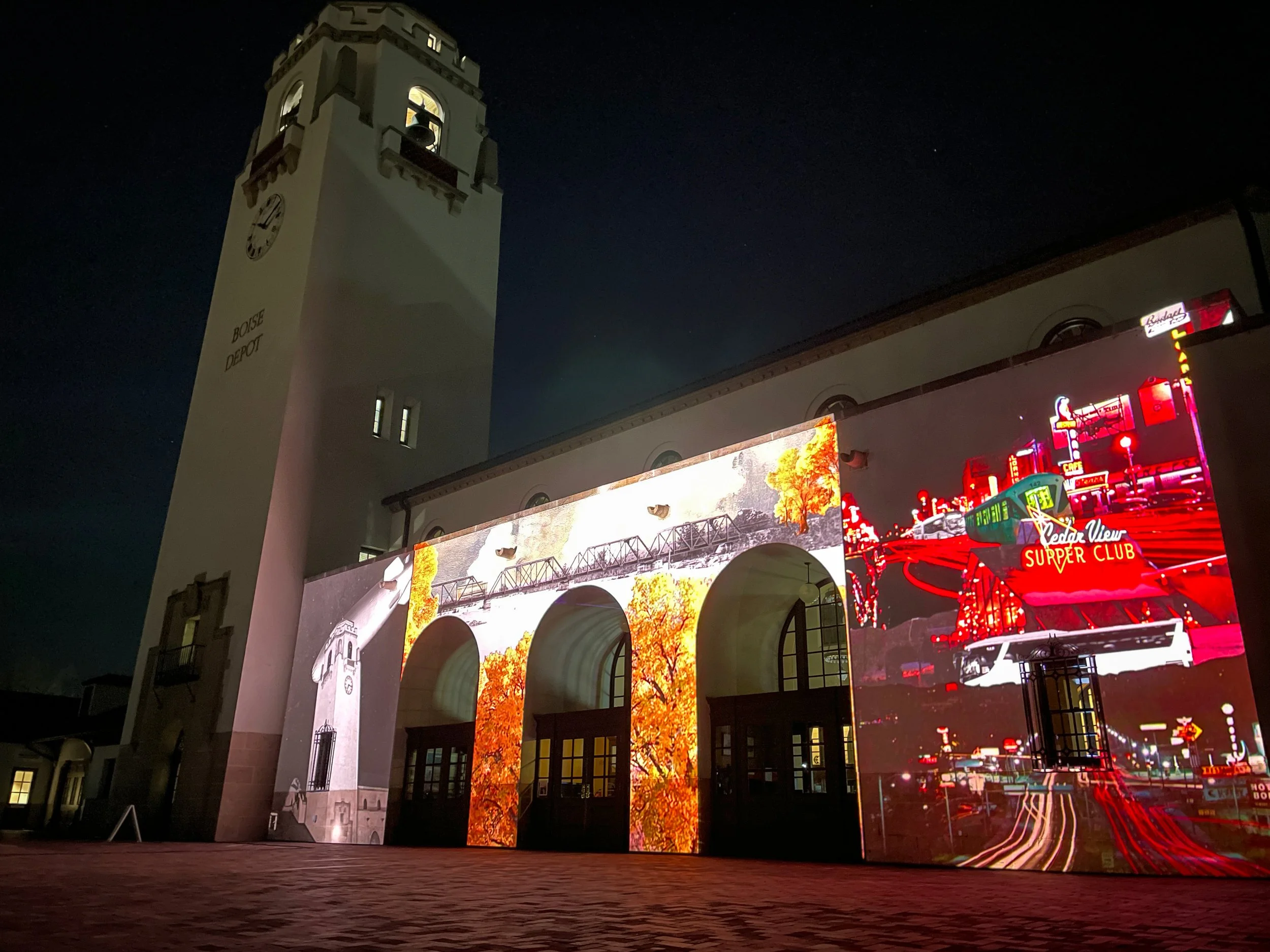 Boise Depot projection mapping at night, autumn bridge and neon Cedar View Supper Club across the arches