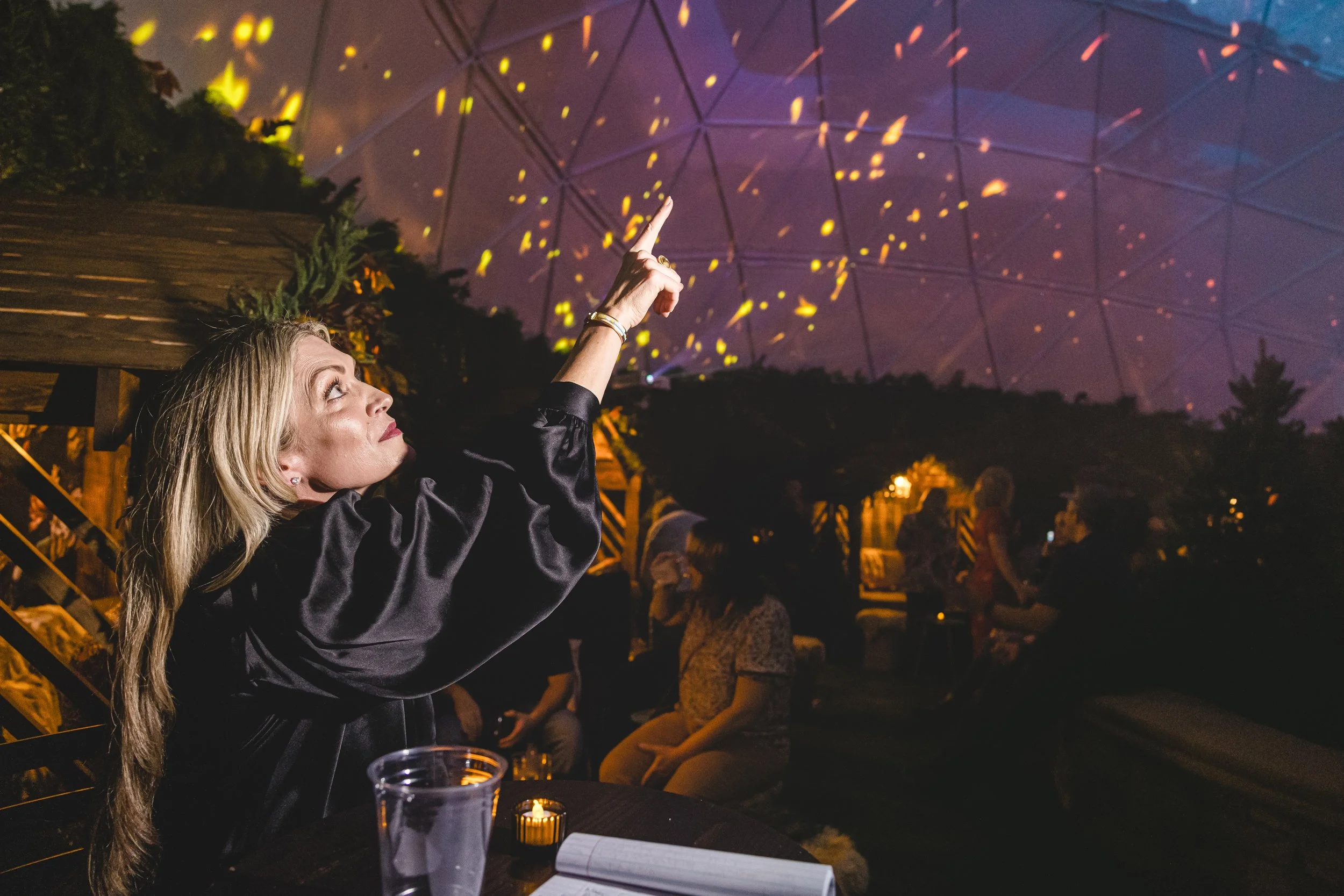 Ember Lounge dome projection at Desert Ridge Marketplace, guest points up at embers drifting across the ceiling