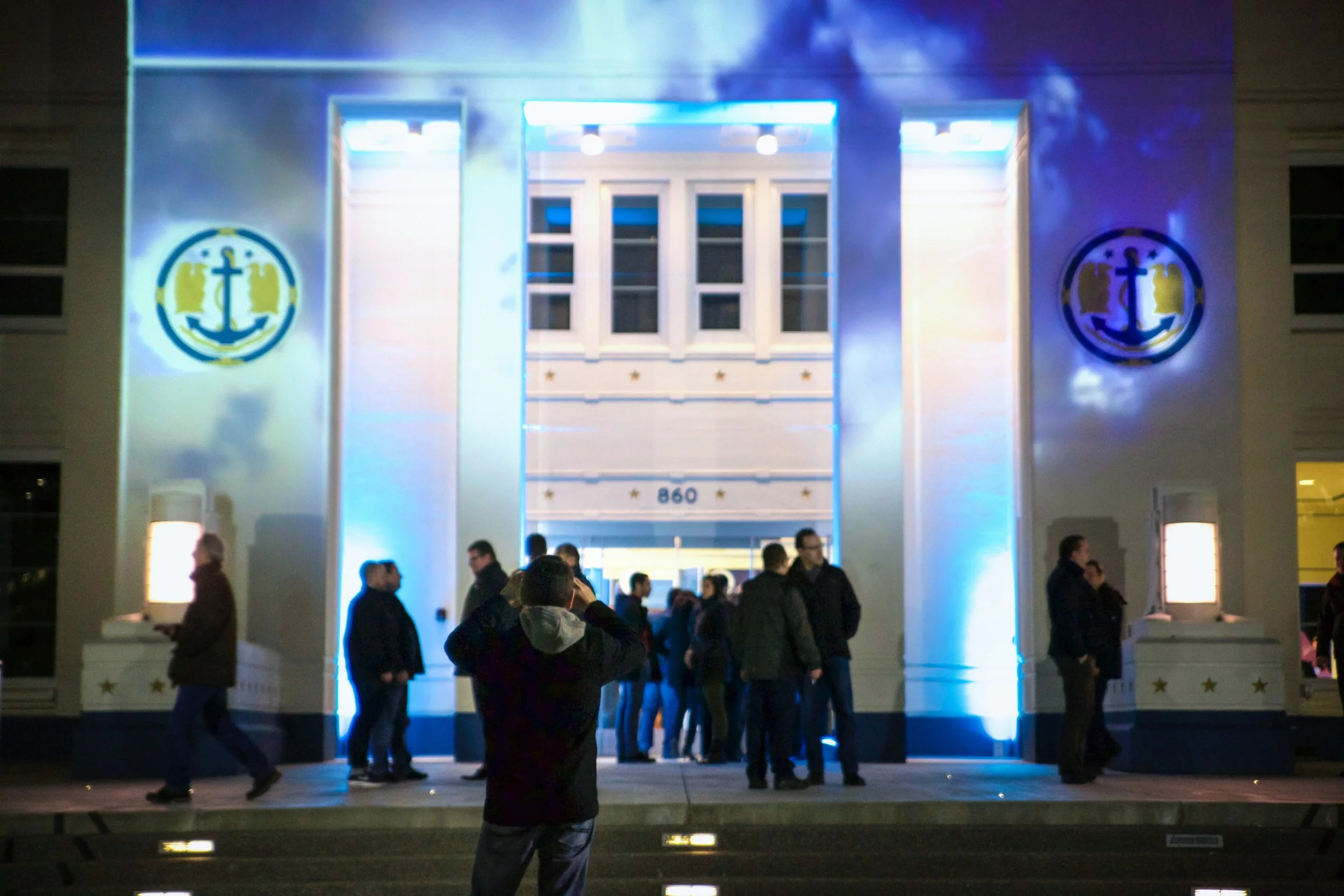 Microsoft at MOHAI projection mapping in Seattle, cloud visuals and anchor emblems above guests at entrance.