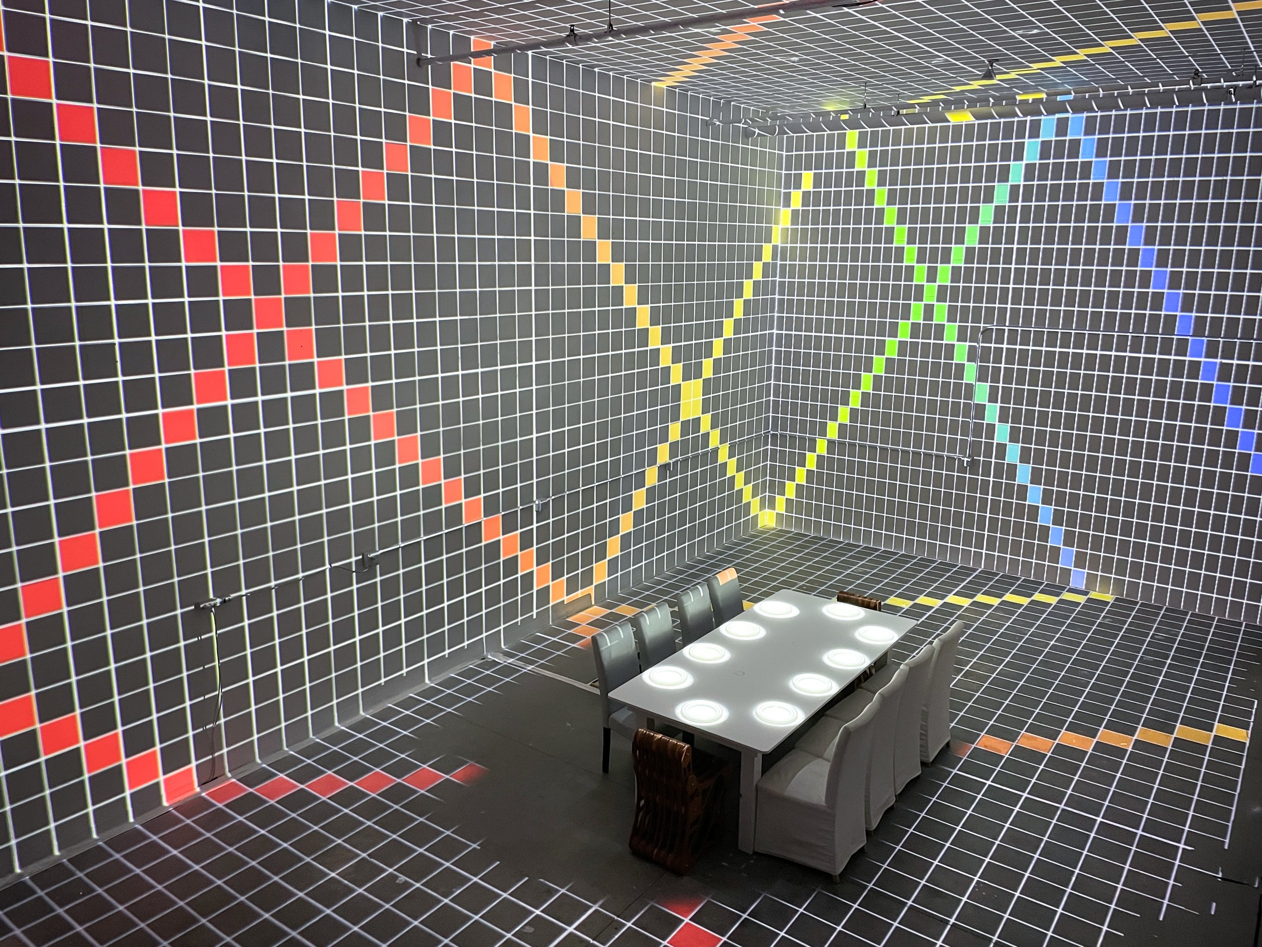 In Studio Immersive Projection Dinner at NOVA Light Labs, calibration grid mapped across every wall and floor