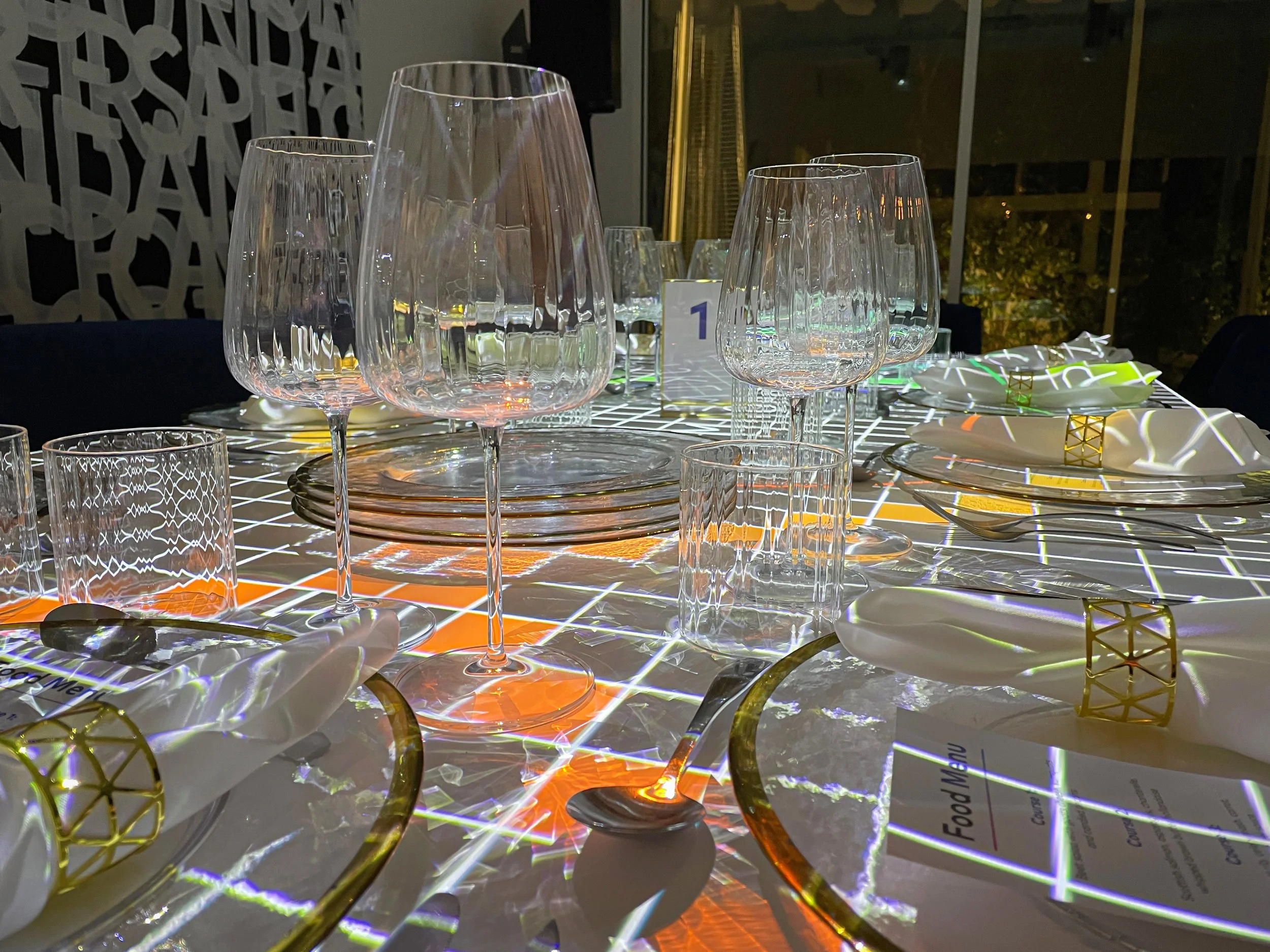 Galleri immersive dining projection mapping at Knife House, grid visuals refracting through crystal glassware
