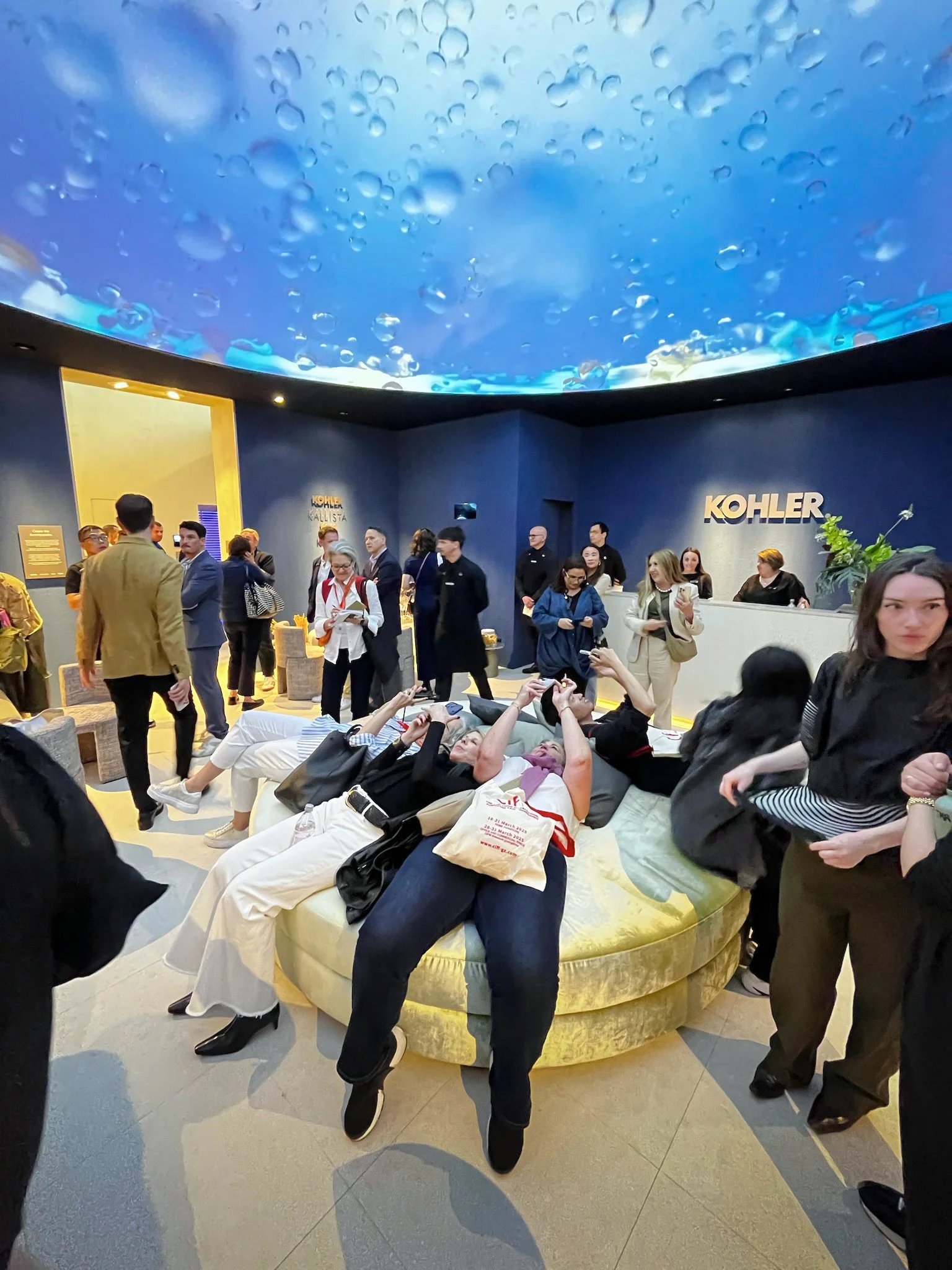 Kohler immersive dome projection at Salone del Mobile, guests reclining on lounge gazing up at water