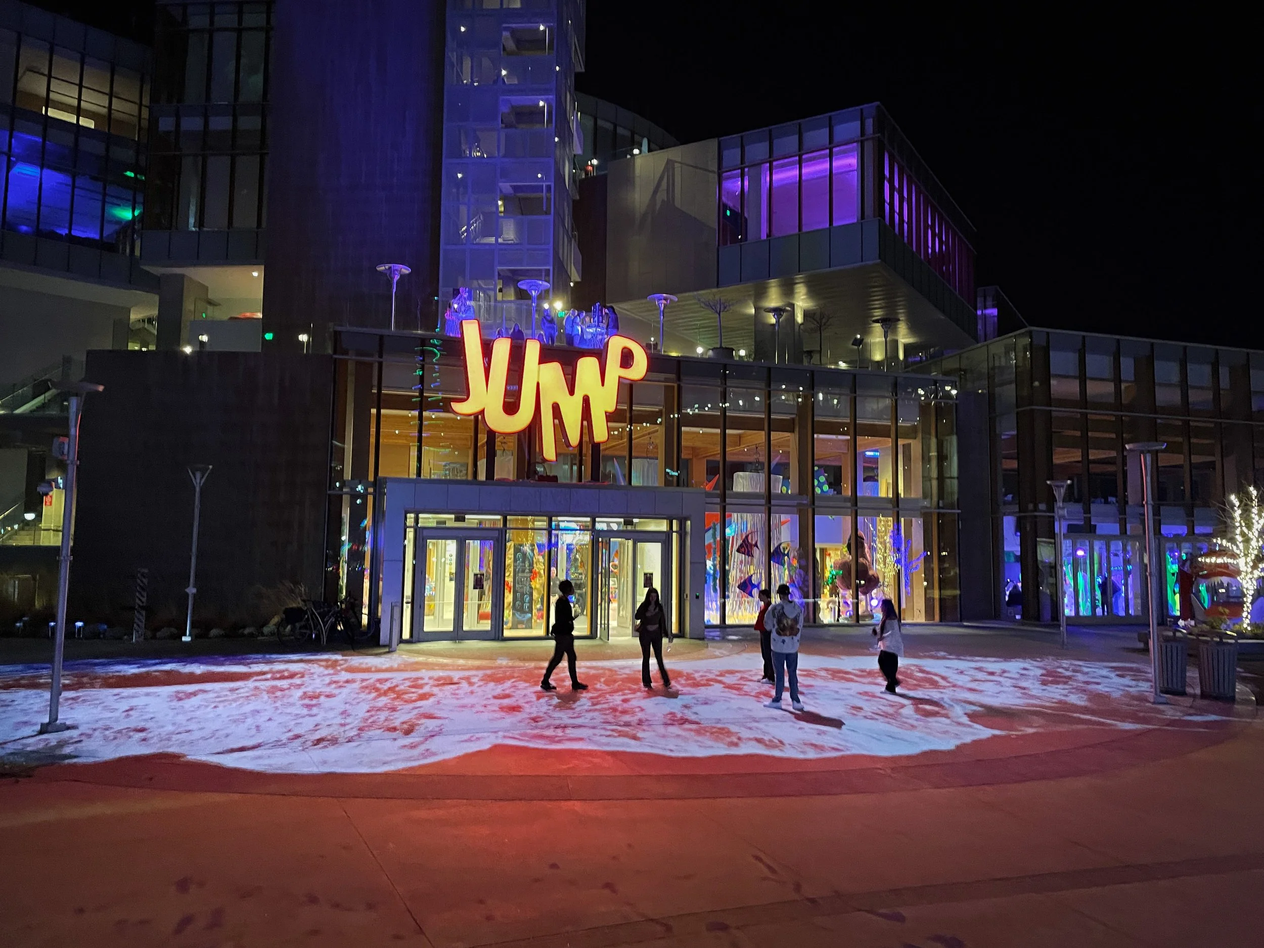 ILLUMIBRATE 2023 projection mapping at JUMP Boise, guests before the entrance in glowing wave light