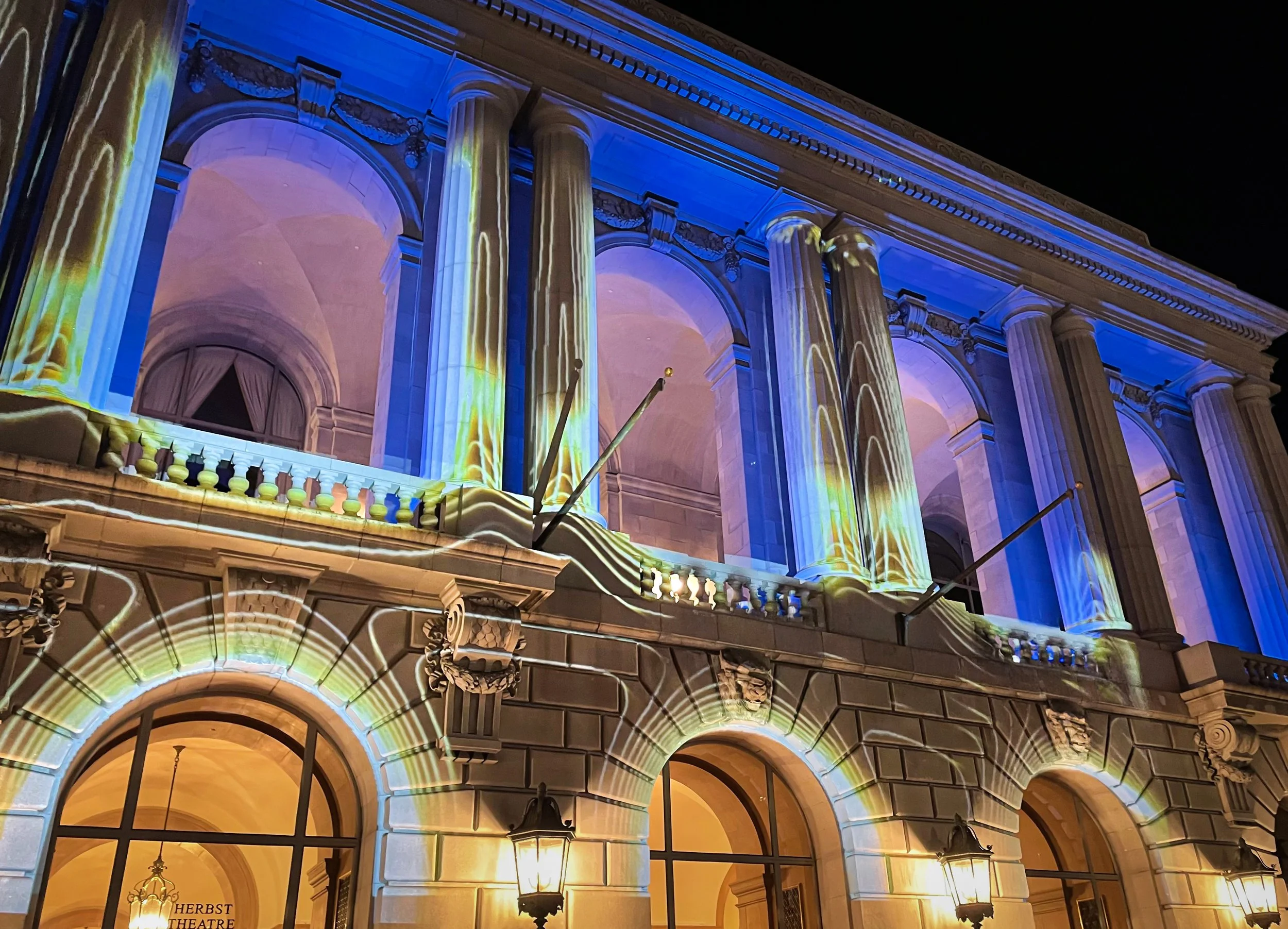 Herbst Theatre exterior projection mapping in San Francisco, facade columns washed in blue and gold light