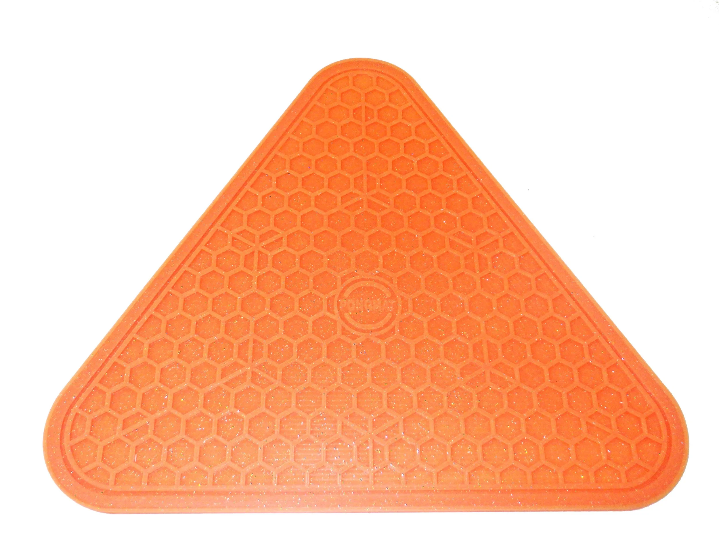 An orange triangular silicone mat with rounded corners and a hexagon pattern throughout.