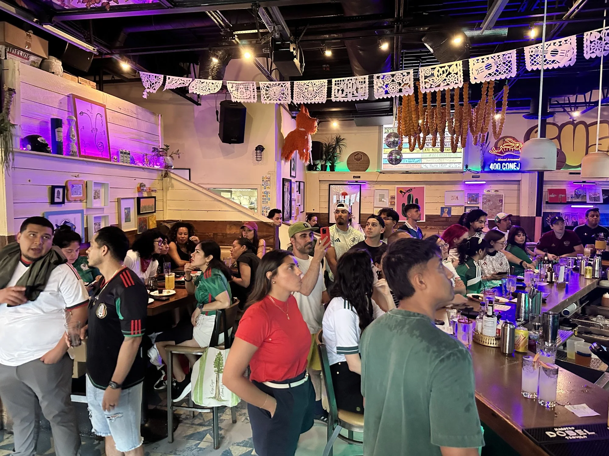 A crowd watching the big game at the Diego bar