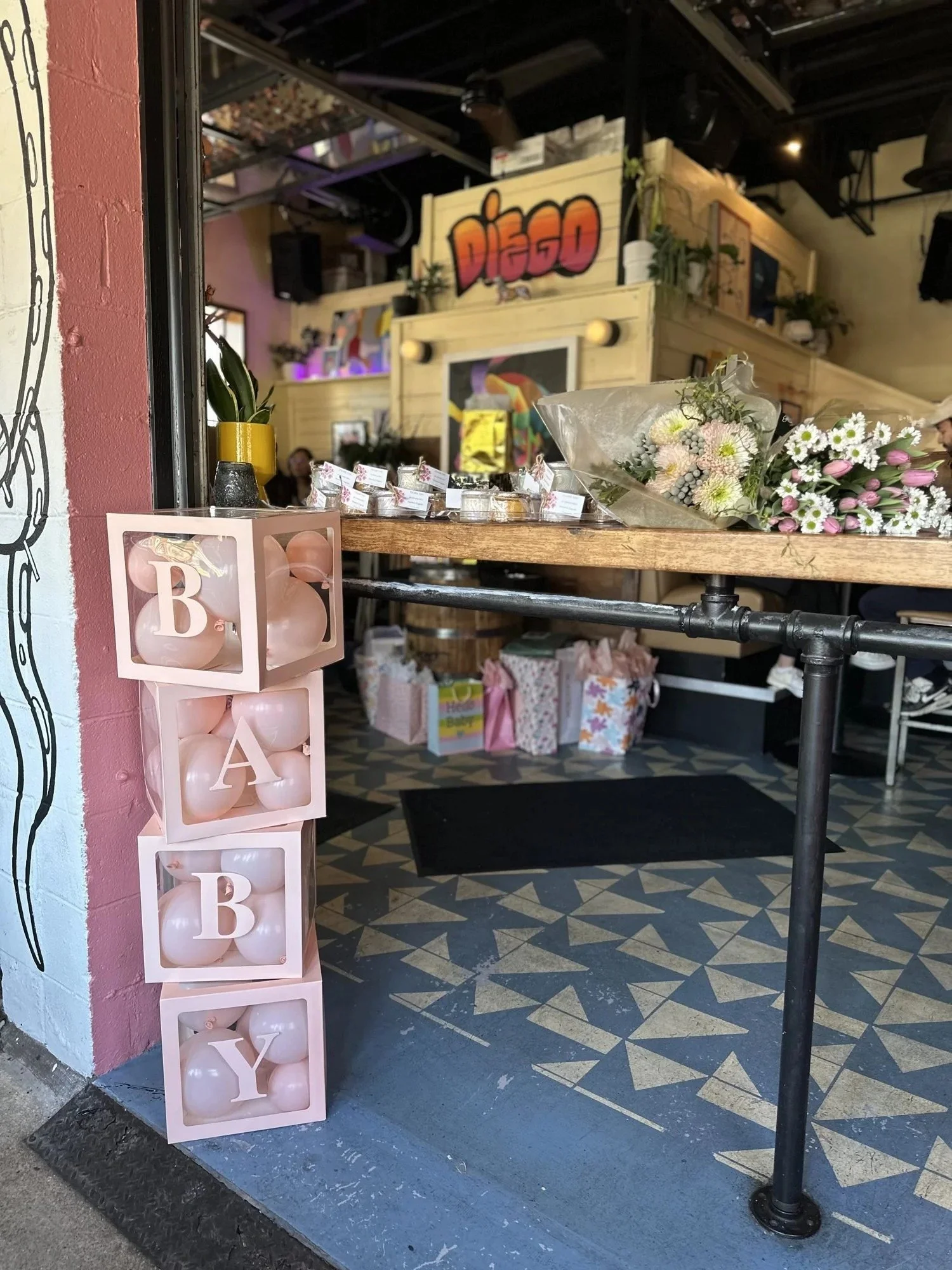 Pink BABY balloon blocks and a gift table set up for a baby shower brunch at Diego in West Town