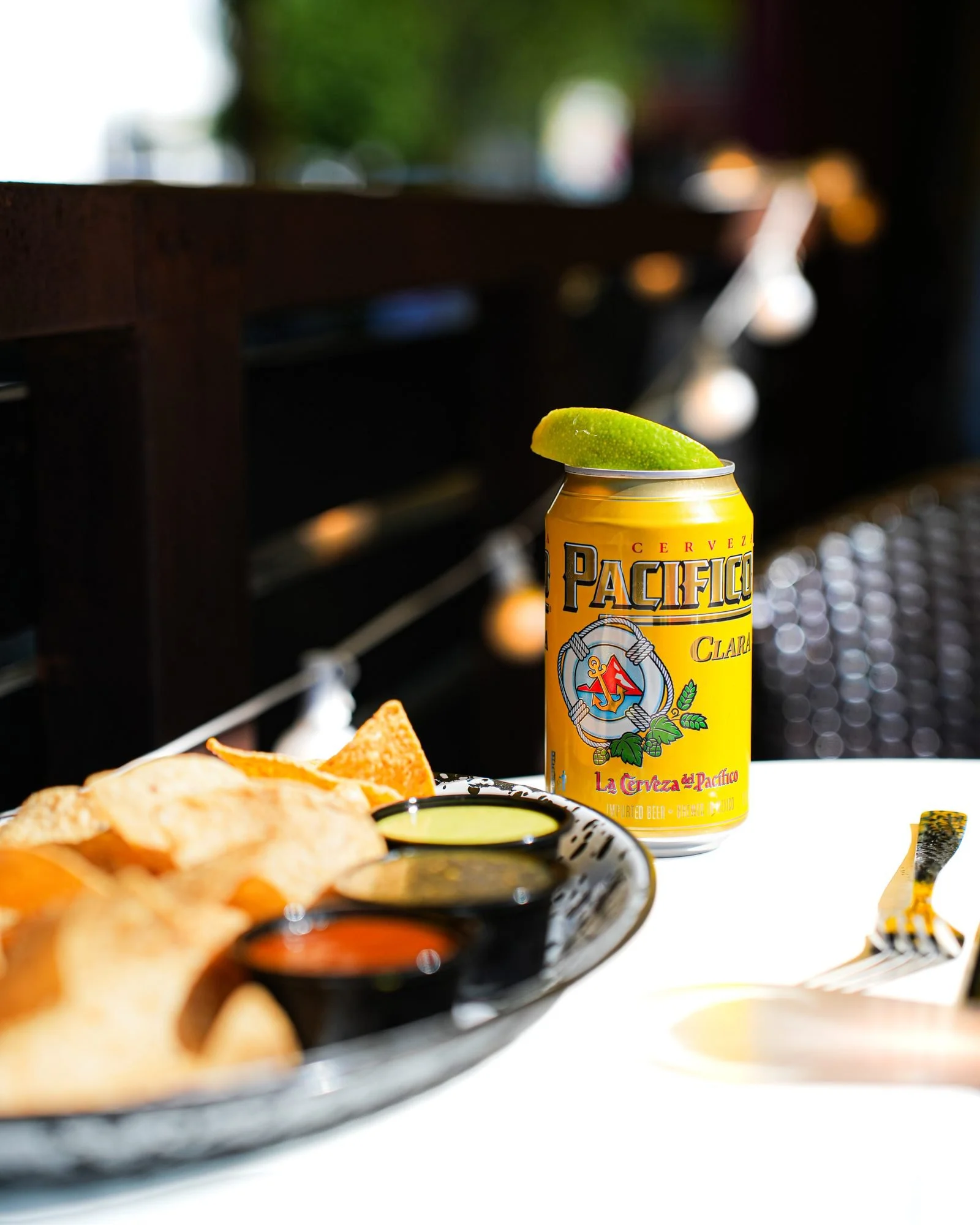 An ice-cold Pacifico with lime and chips and salsa on the patio at Diego in West Town