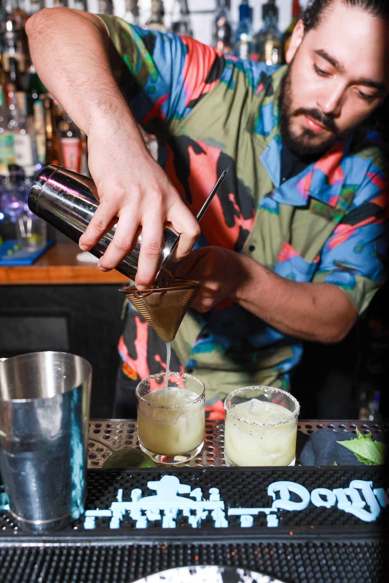 A Diego bartender straining a margarita in West Town