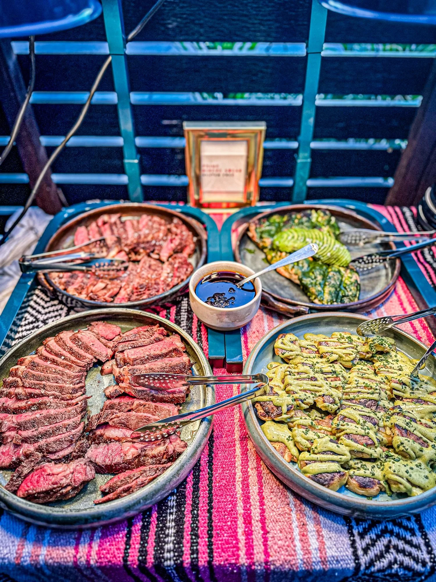 Sliced prime steak and share plates set out for a group event at Diego in West Town