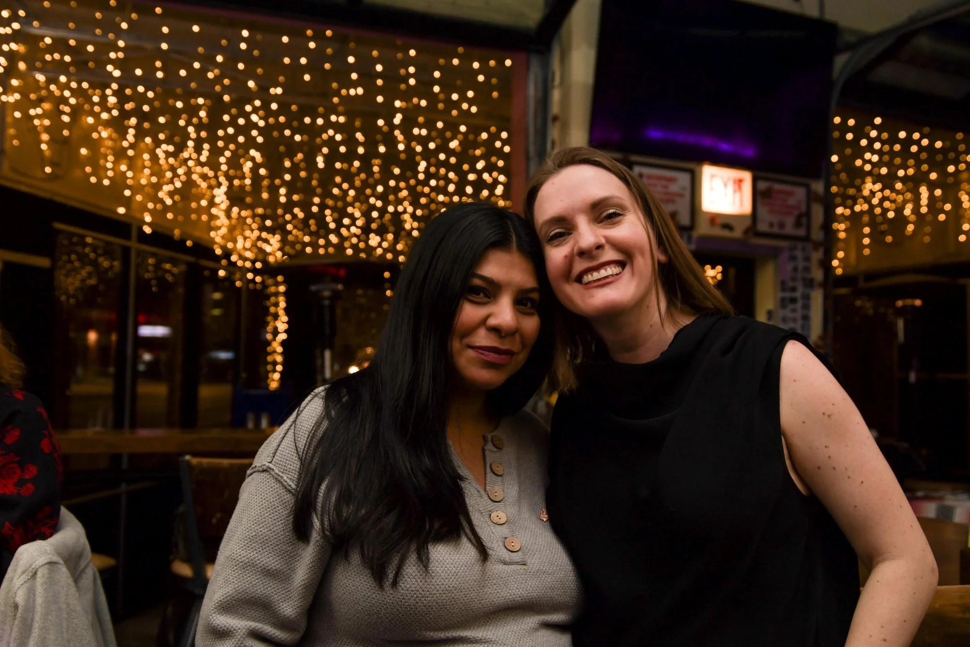Friends under string lights at Diego, West Town Chicago