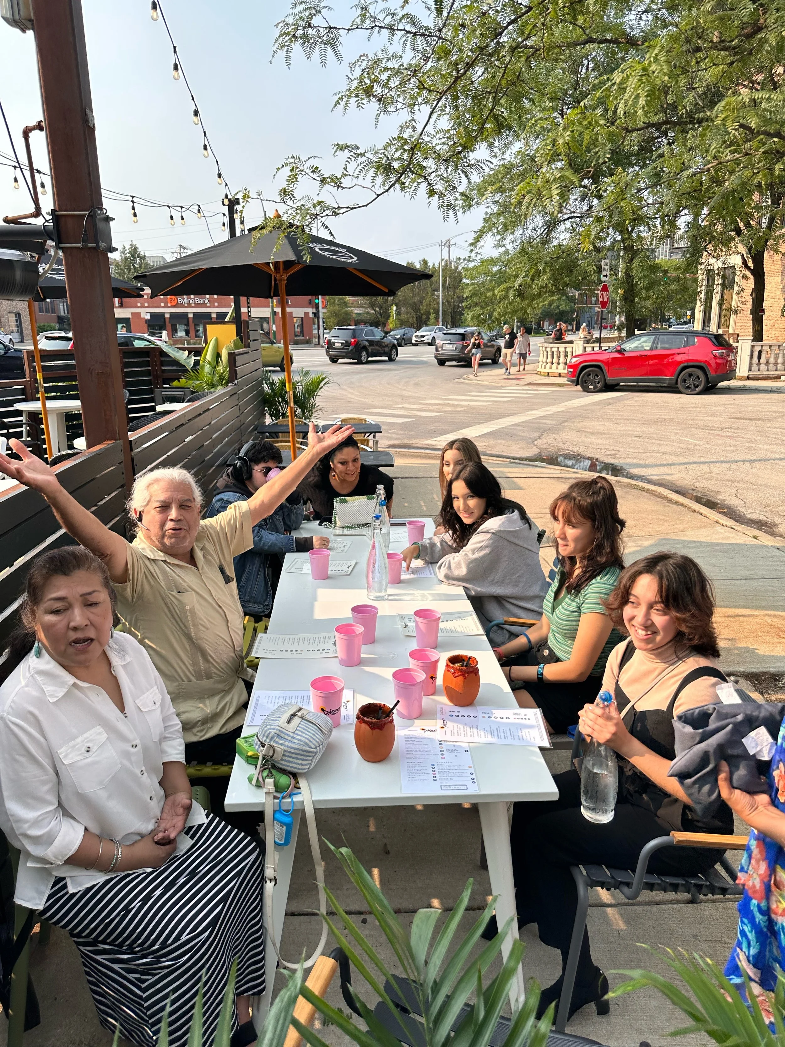 Group at a patio table outside Diego