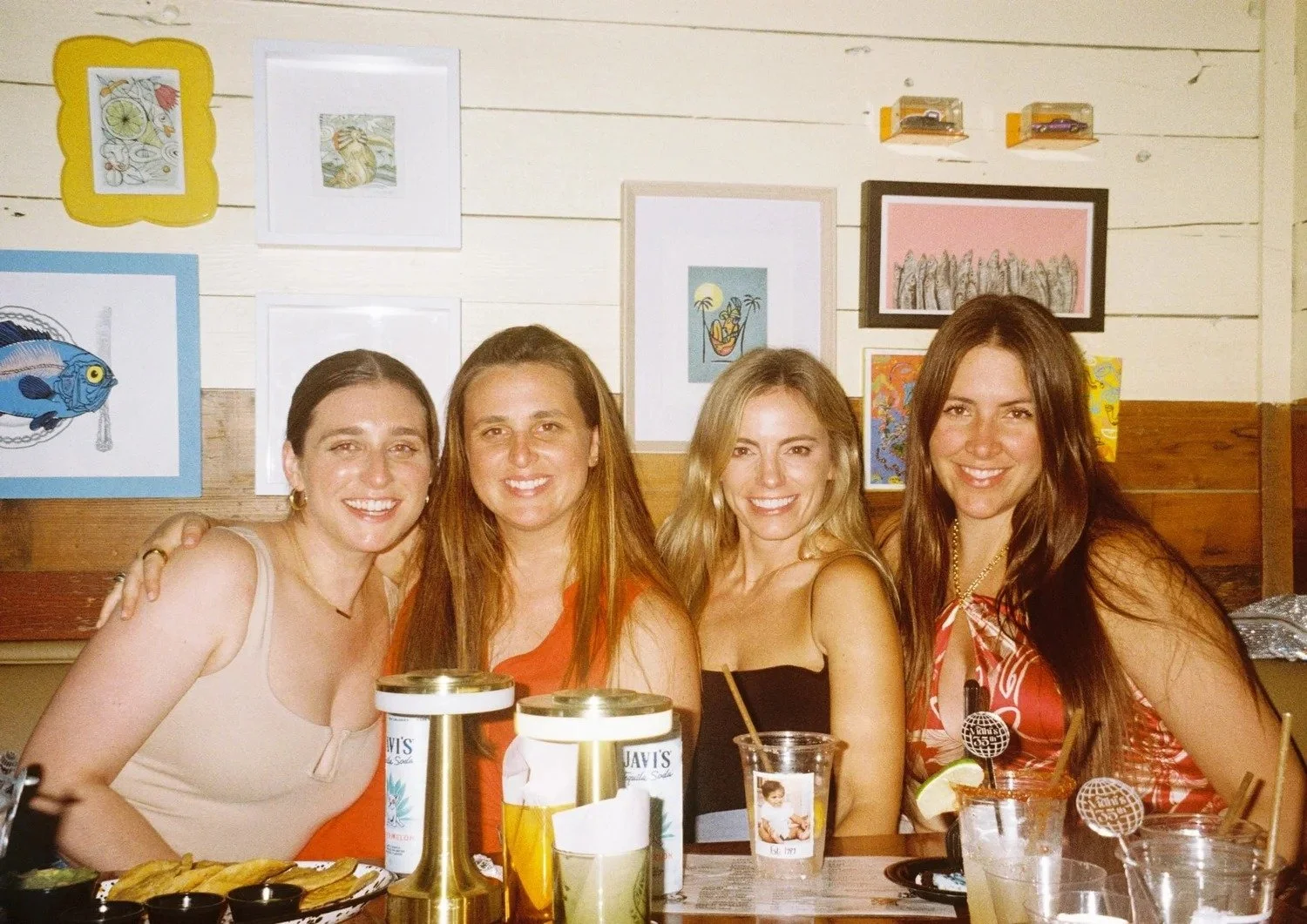 Friends seated together at a table inside Diego, West Town