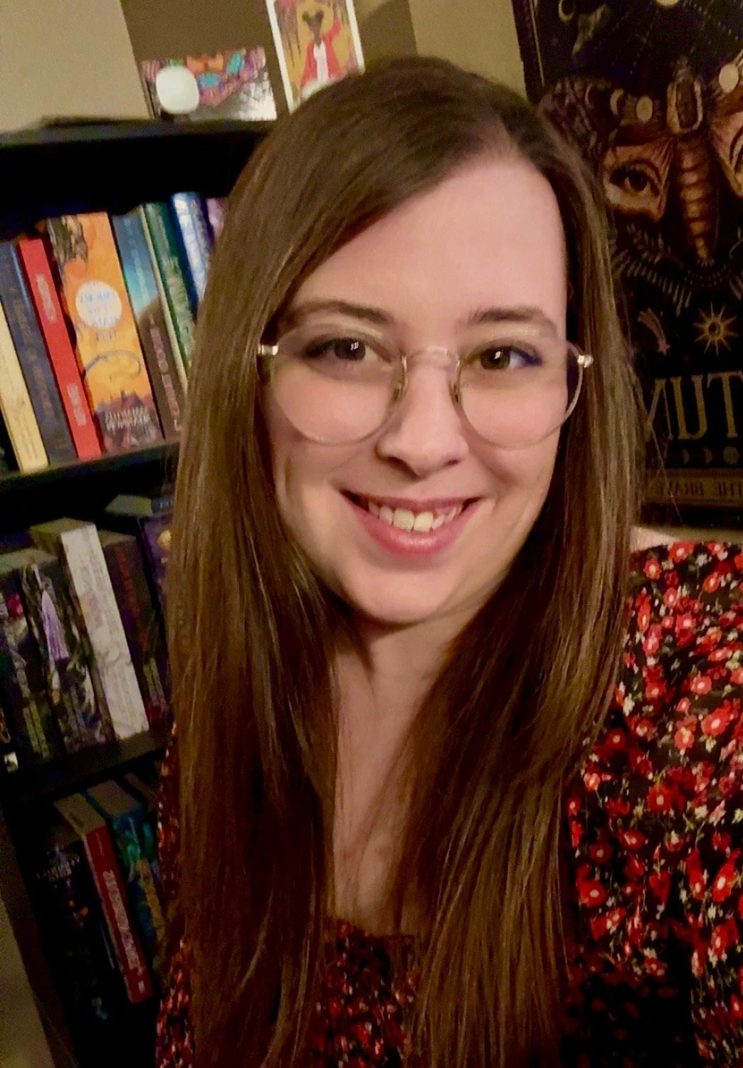 Riley, customer service advocate at Pawlyclinic, smiling in front of a bookshelf — supporting clients and pets with empathy and communication