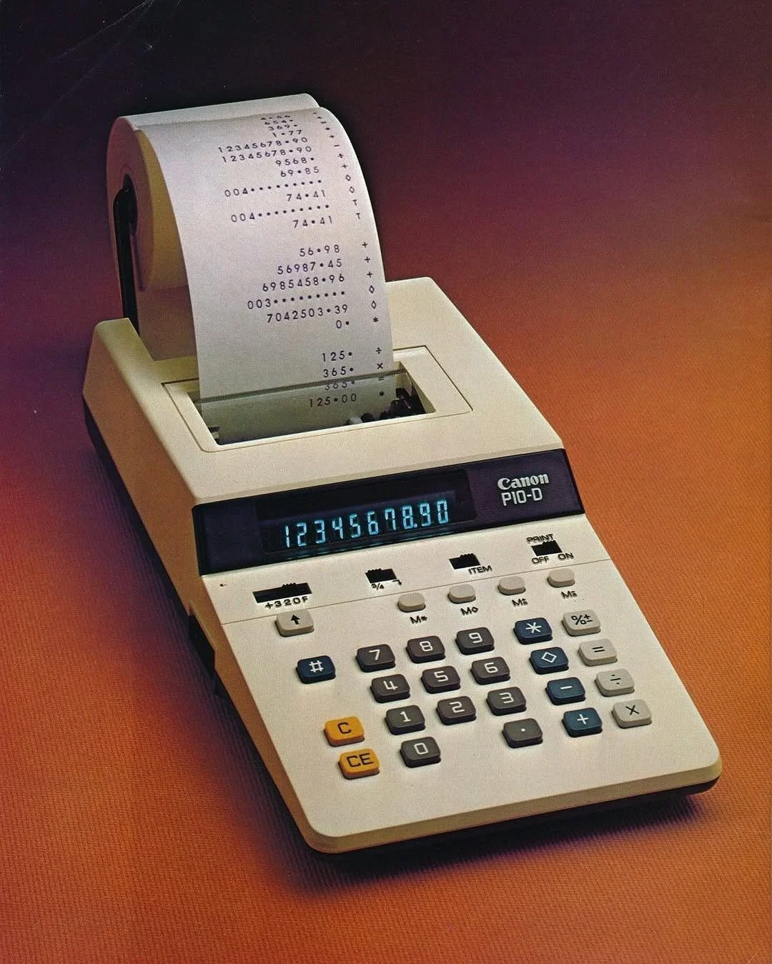 A Canon PIO-D printing calculator with a receipt coming out, displaying numbers 1234567890 on the small screen.