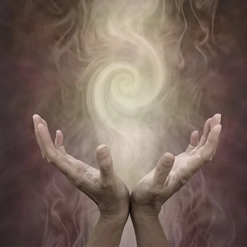 Two hands raised with palms up, holding swirling, glowing smoke or mist in the shape of a spiral or vortex.
